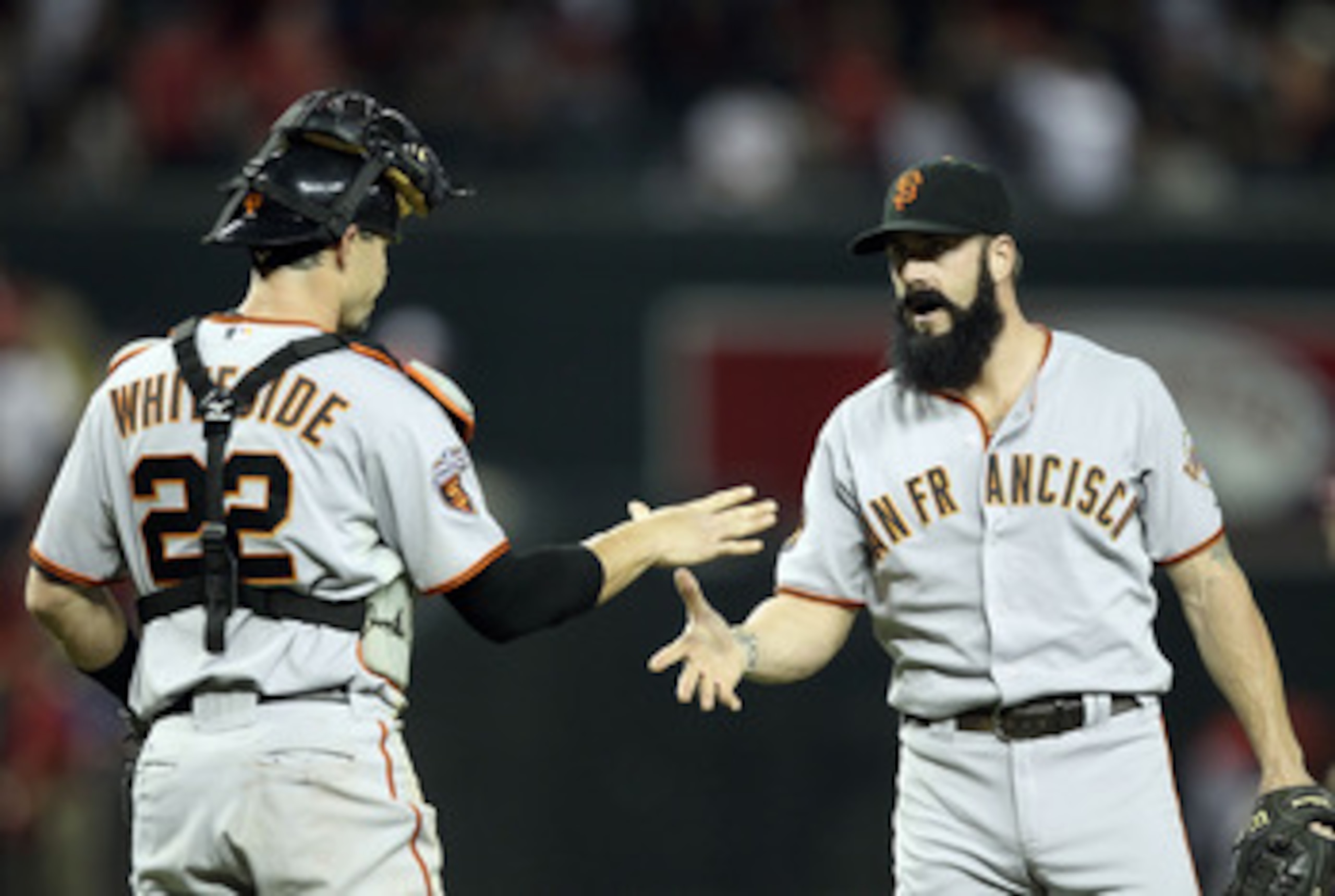 PHOENIX, AZ - JUNE 15:  Relief pitcher Brian Wilson #38 of the San Francisco Giants celebrates with catcher Eli Whiteside #22 after defeating the Arizona Diamondbacks in the Major League Baseball game at Chase Field on June 15, 2011 in Phoenix, Arizona. T