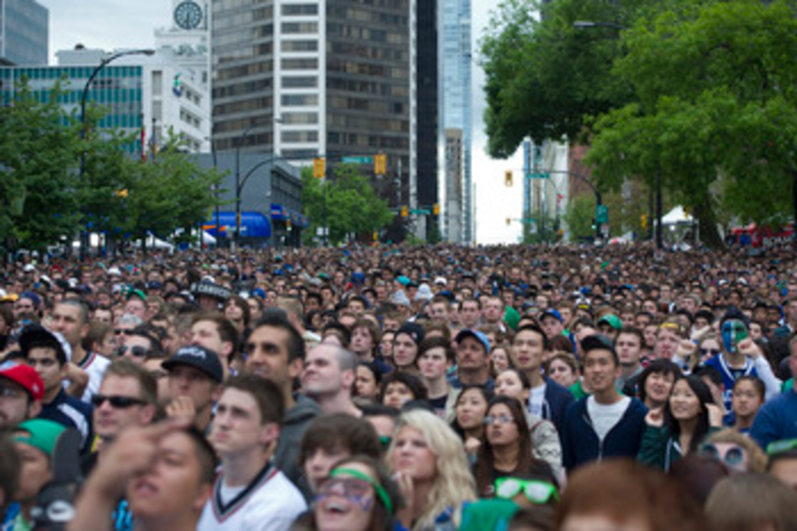 VANCOUVER, CANADA - JUNE 13: Fans gather on the streets of downtown Vancouver to watch Game Six of the 2011 NHL Stanley Cup Playoffs on June 13, 2011 in Vancouver, British Columbia, Canada.  (Photo by Rich Lam/Getty Images)