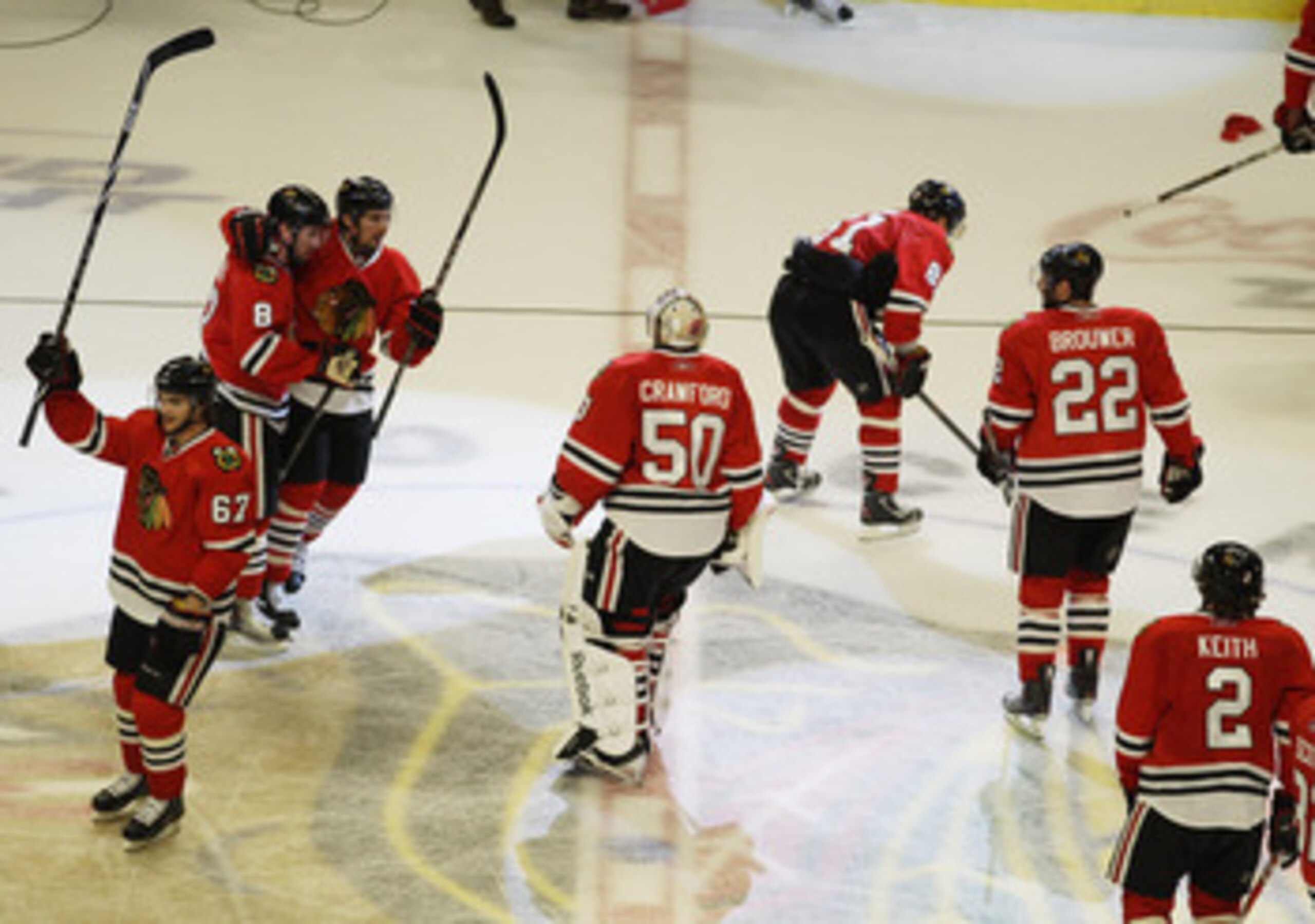 CHICAGO, IL - APRIL 24: Members of the Chicago Blackhawks including Corey Crawford #50 salute the crowd and celebrate a win over the Vancouver Canucks in Game Six of the Western Conference Quarterfinals during the 2011 NHL Stanley Cup Playoffs at the Unit
