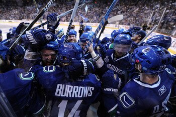 VANCOUVER, BC - JUNE 04:  Alex Burrows #14 of the Vancouver Canucks celebrates with his teammates after scoring a goal in overtime against Zdeno Chara #33 of the Boston Bruins to win Game Two of the 2011 NHL Stanley Cup Final at Rogers Arena on June 4, 20