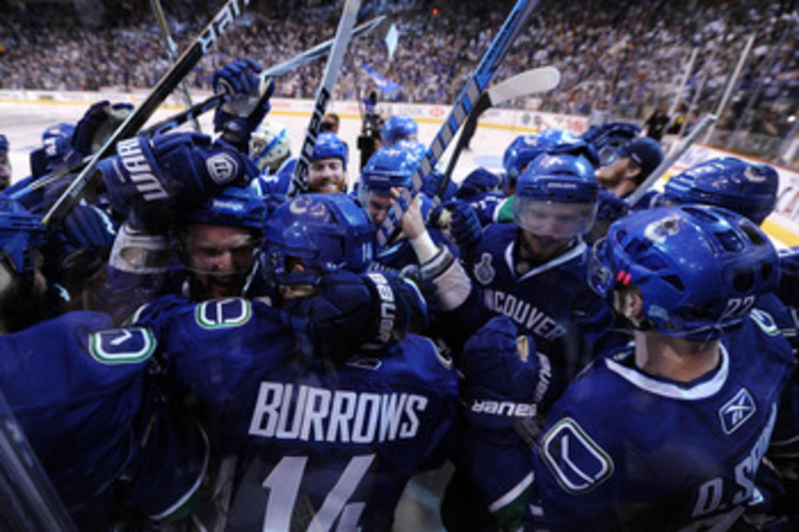 VANCOUVER, BC - JUNE 04:  Alex Burrows #14 of the Vancouver Canucks celebrates with his teammates after scoring a goal in overtime against Zdeno Chara #33 of the Boston Bruins to win Game Two of the 2011 NHL Stanley Cup Final at Rogers Arena on June 4, 20