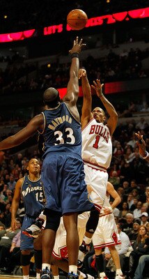 CHICAGO - JANUARY 15: Derrick Rose #1 of the Chicago Bulls puts up a shot on his way to a game and career high 37 points against Brendan Haywood #33 of the Washington Wizards at the United Center on January 15, 2010 in Chicago, Illinois. The Bulls defeate
