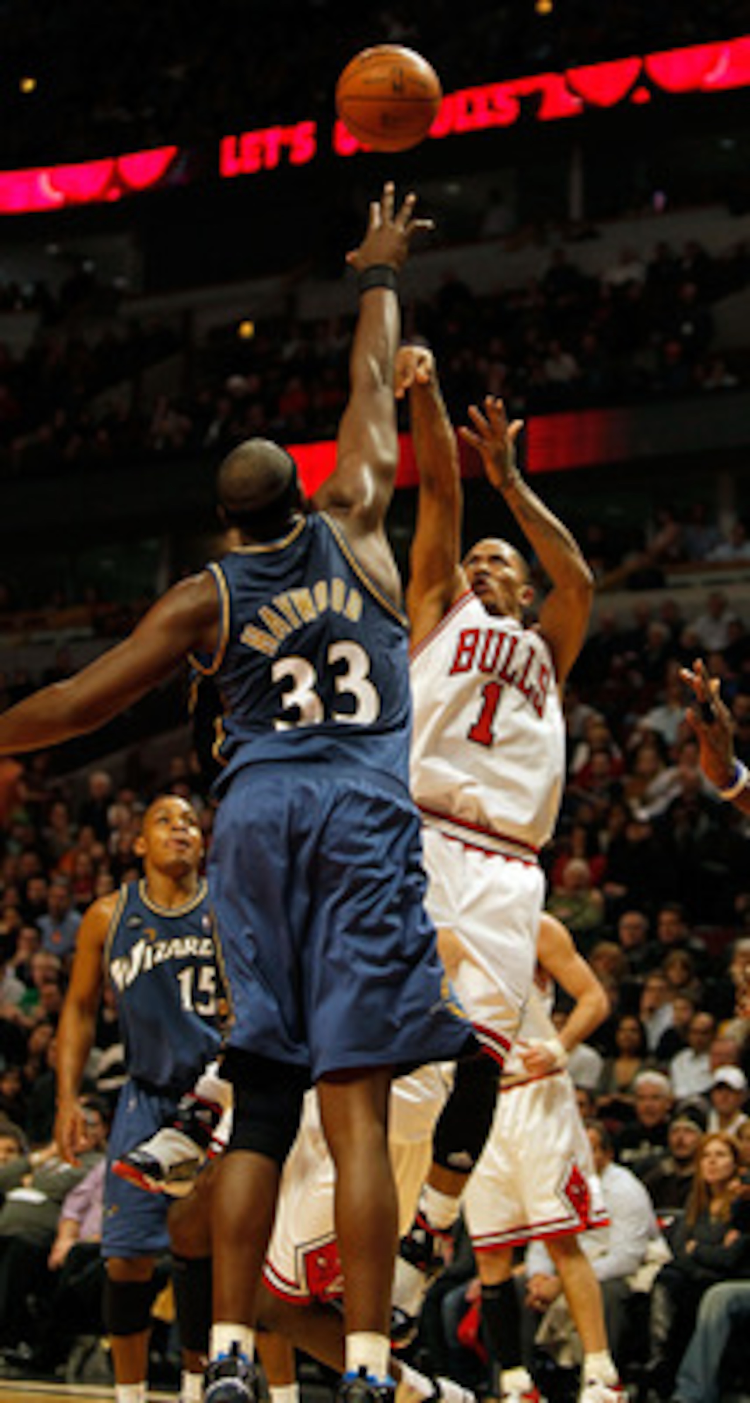 CHICAGO - JANUARY 15: Derrick Rose #1 of the Chicago Bulls puts up a shot on his way to a game and career high 37 points against Brendan Haywood #33 of the Washington Wizards at the United Center on January 15, 2010 in Chicago, Illinois. The Bulls defeate