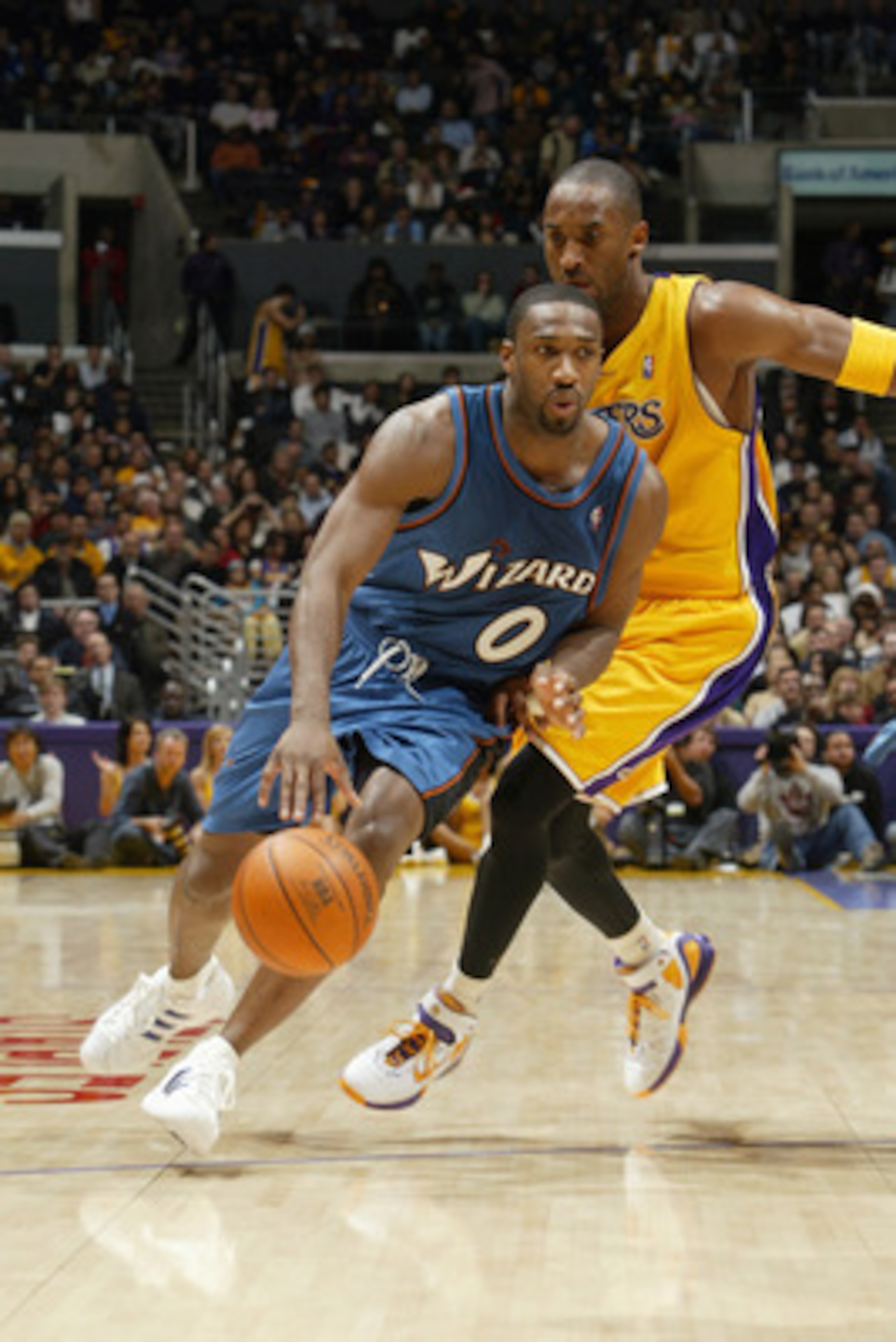 LOS ANGELES - DECEMBER 16:  Gilbert Arenas #0 of the Washington Wizards drives past Kobe Bryant #8 of the Los Angeles Lakers during a game at Staples Center on December 16, 2005 in Los Angeles, California.  The Lakers won 97-91.  NOTE TO USER:  User expre