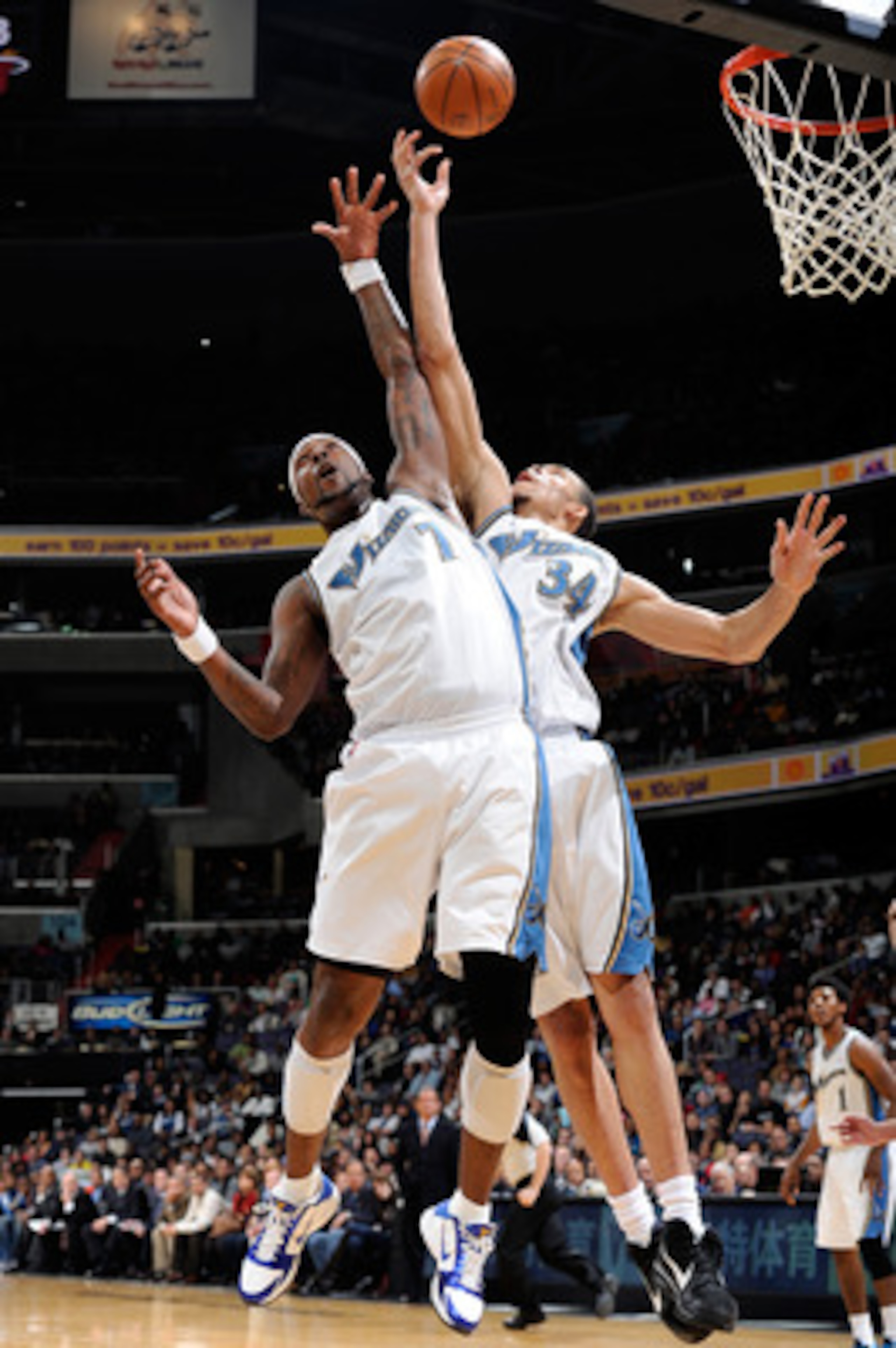 WASHINGTON, DC - DECEMBER 18:  JaVale McGee #34 and Andray Blatche #7 of the Washington Wizards jump for a rebound against the Miami Heat at the Verizon Center on December 18, 2010 in Washington, DC. NOTE TO USER: User expressly acknowledges and agrees th