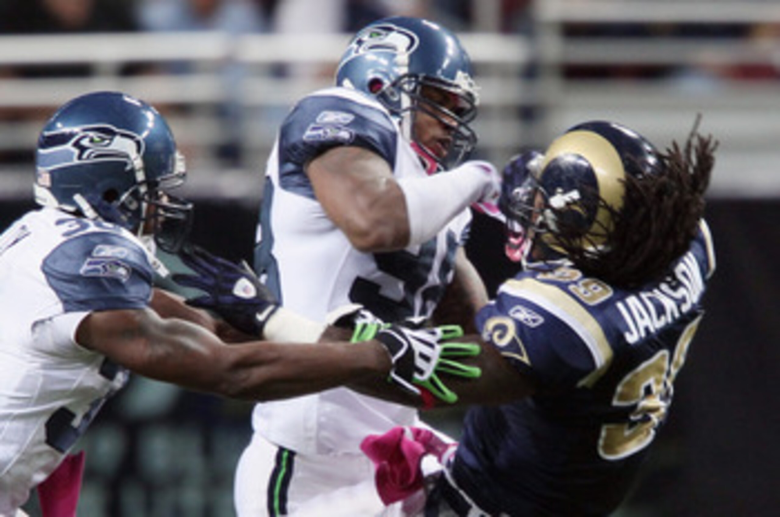 ST. LOUIS - OCTOBER 03:  Raheem Brock #98 and Lawyer Milloy #36 of the Seattle Seahawks take down Steven Jackson #39 of the St. Louis Rams on October 3, 2010 at Edward Jones Dome in St. Louis, Missouri.  (Photo by Elsa/Getty Images)