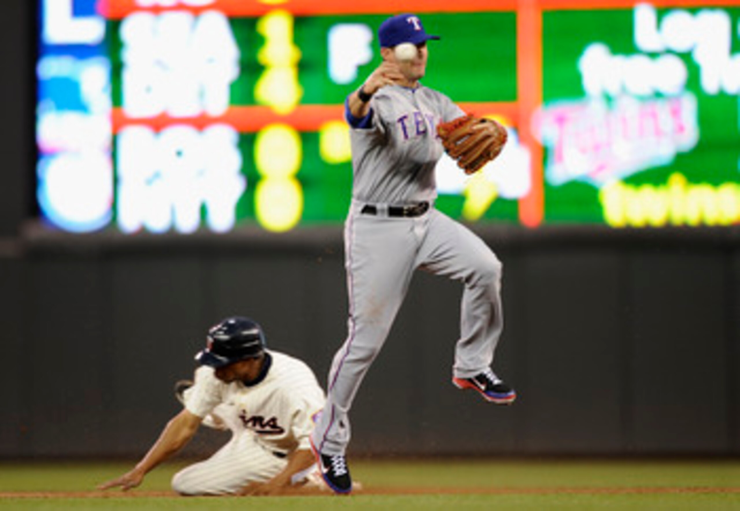 MINNEAPOLIS, MN - JUNE 9: Ben Revere #11 of the Minnesota Twins is out at second base as Michael Young #10 of the Texas Rangers throws to first base during the fifth inning of their game on June 9, 2011 at Target Field in Minneapolis, Minnesota. (Photo by