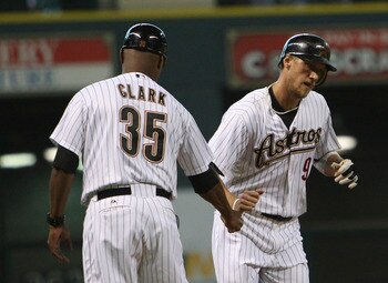 HOUSTON - JUNE 13:  Hunter Pence #9 of the Houston Astros receives congratulations from third base coach Dave Clark #35 after a hitting a home run in the third inning against the Atlanta Braves at Minute Maid Park on June 13, 2011 in Houston, Texas.  (Pho