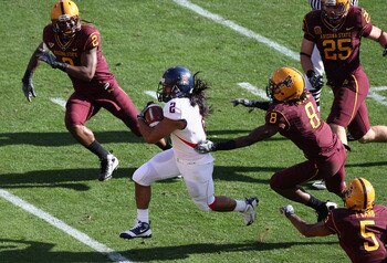 TEMPE, AZ - NOVEMBER 28:  Wide reciver Keola Antolin #2 of the Arizona Wildcats rushes for a 68 yard touchdown past Jarrell Holman #8 of the Arizona State Sun Devils during the college football game at Sun Devil Stadium on November 28, 2009 in Tempe, Ariz