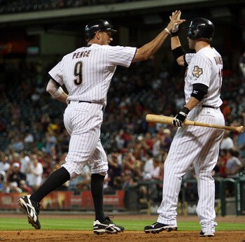 HOUSTON - JUNE 13:  Hunter Pence #9 of the Houston Astros receives congratulations from Clint Barmes #12 after a hitting a home run in the third inning against the Atlanta Braves at Minute Maid Park on June 13, 2011 in Houston, Texas.  (Photo by Bob Levey