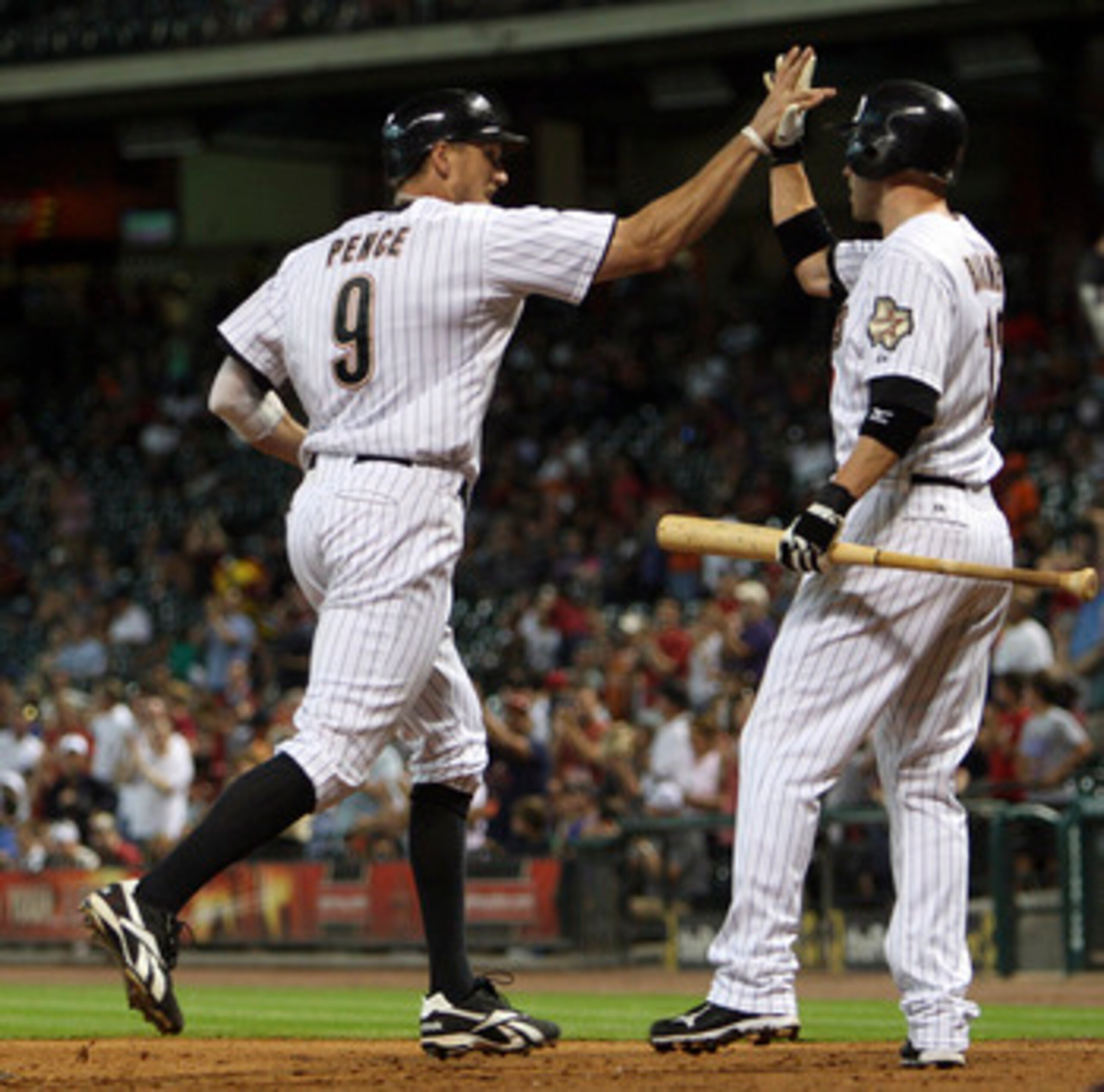 HOUSTON - JUNE 13: Hunter Pence #9 of the Houston Astros receives congratulations from Clint Barmes #12 after a hitting a home run in the third inning against the Atlanta Braves at Minute Maid Park on June 13, 2011 in Houston, Texas. (Photo by Bob Levey HOUSTON - JUNE 13: Hunter Pence #9 of the Houston Astros receives congratulations from Clint Barmes #12 after a hitting a home run in the third inning against the Atlanta Braves at Minute Maid Park on June 13, 2011 in Houston, Texas. (Photo by Bob Levey