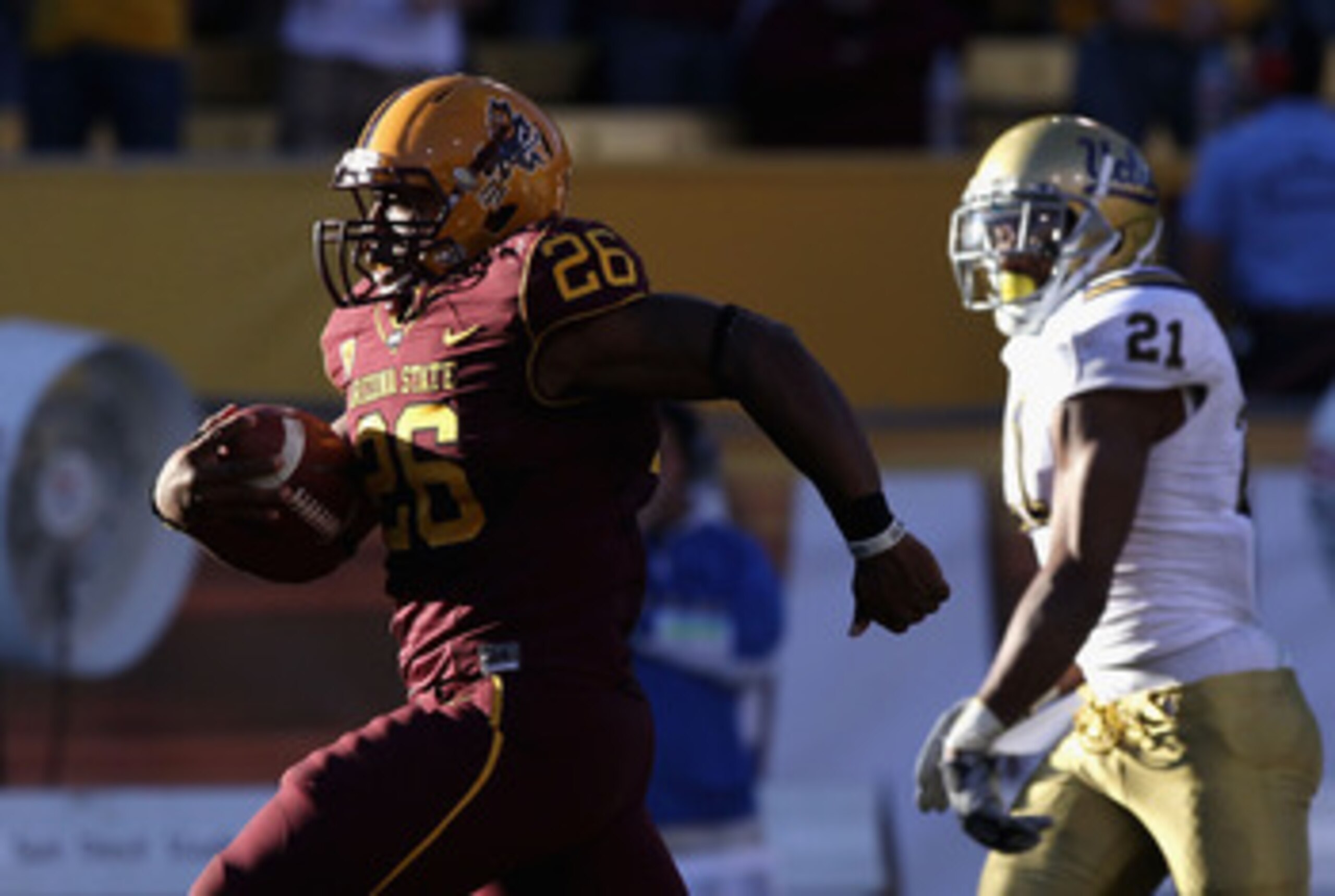 TEMPE, AZ - NOVEMBER 26:  Runningback Cameron Marshall #26 of the Arizona State Sun Devils carries the football for a 71 yard rushing touchdown against the UCLA Bruins during the thrid quarter of the college football game at Sun Devil Stadium on November