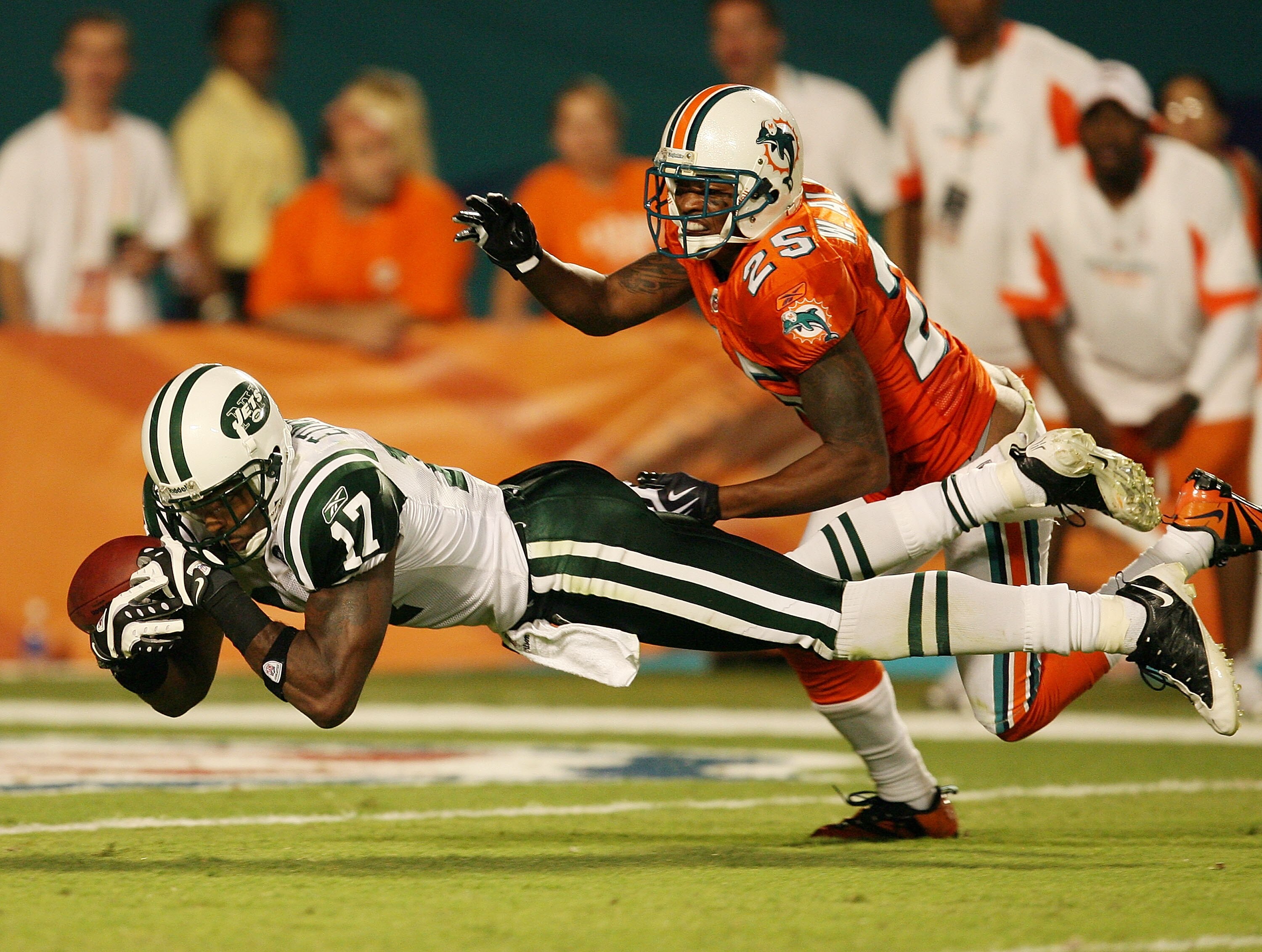 MIAMI - OCTOBER 12:  Wide receiver Braylon Edwards #17 of the New York Jets can't come up with a catch after being interfered with by cornerback Will Allen #25 of the Miami Dolphins at Land Shark Stadium on October 12, 2009 in Miami, Florida. The Dolphins