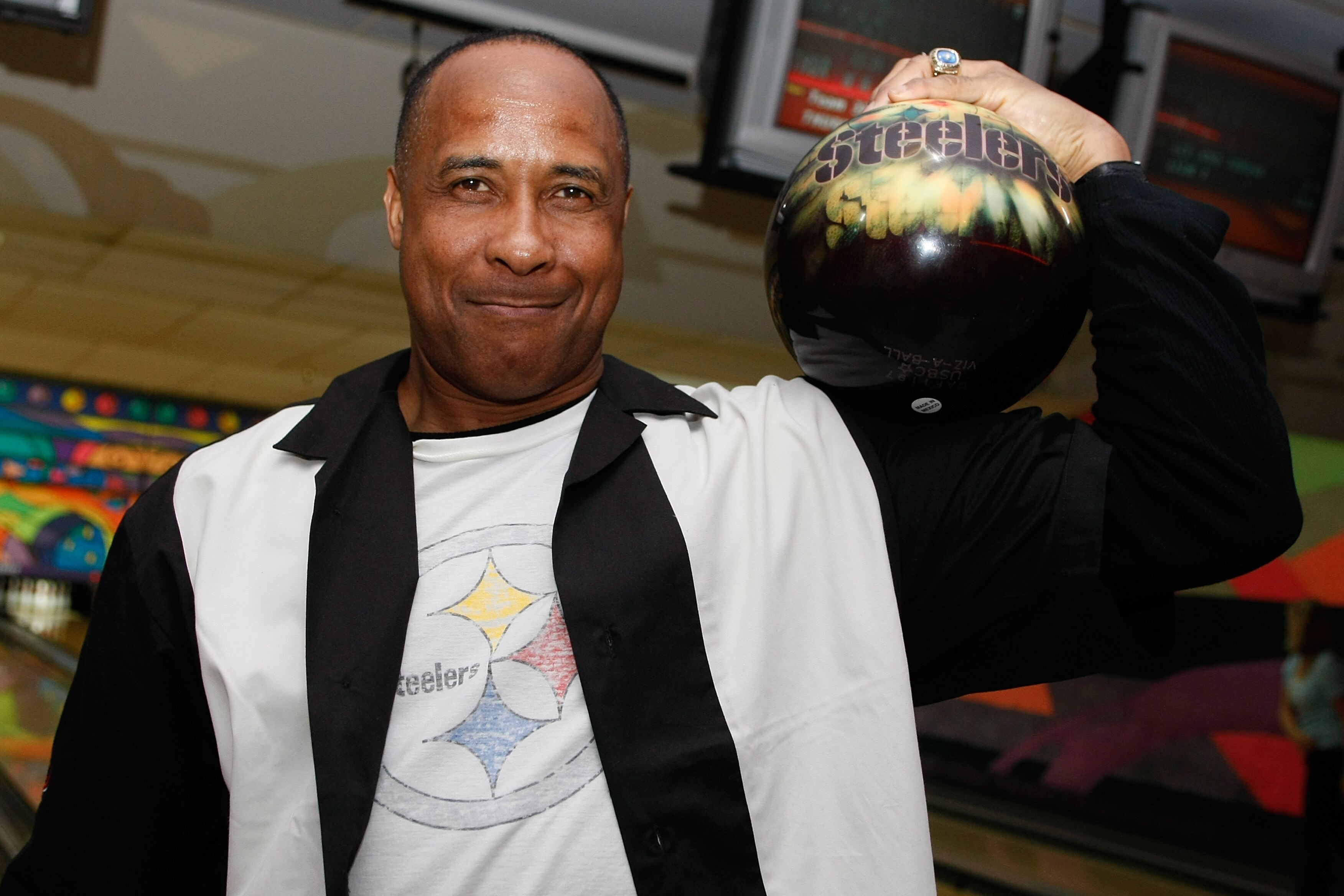 TAMPA, FL - JANUARY 28: Pro Football Hall of Fame member  Lynn Swann holds a Pittsburgh Steelers bowling ball on his arm during the Super Bowl Bowl Celebrity Classic at Pin Chasers Veterans Bowling Center on January 28, 2009 in Tampa, Florida. (Scott Boeh