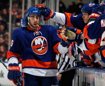 UNIONDALE, NY - FEBRUARY 21:  Matt Moulson #26 of the New York Islanders is congratulated by teammates on the bench after scoring an empty net goal for a hat trick late in the third period of an NHL hockey game against the Florida Panthers at the Nassau C