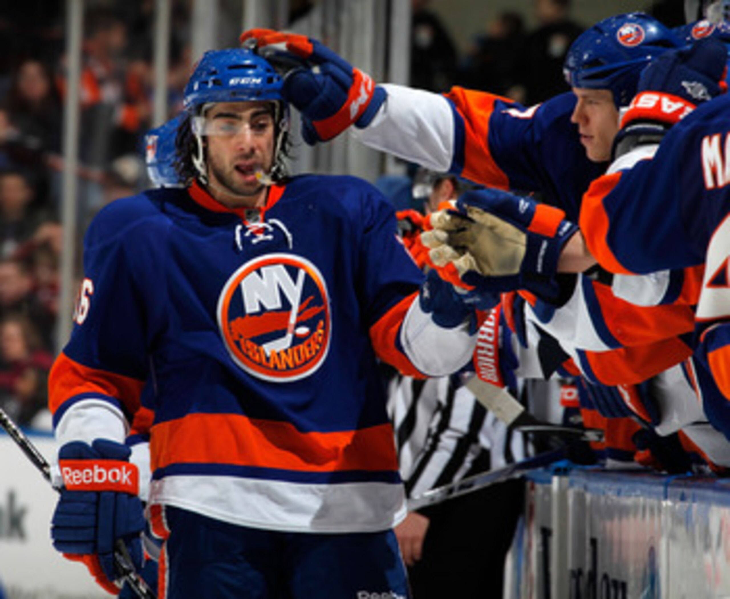 UNIONDALE, NY - FEBRUARY 21: Matt Moulson #26 of the New York Islanders is congratulated by teammates on the bench after scoring an empty net goal for a hat trick late in the third period of an NHL hockey game against the Florida Panthers at the Nassau C UNIONDALE, NY - FEBRUARY 21: Matt Moulson #26 of the New York Islanders is congratulated by teammates on the bench after scoring an empty net goal for a hat trick late in the third period of an NHL hockey game against the Florida Panthers at the Nassau C