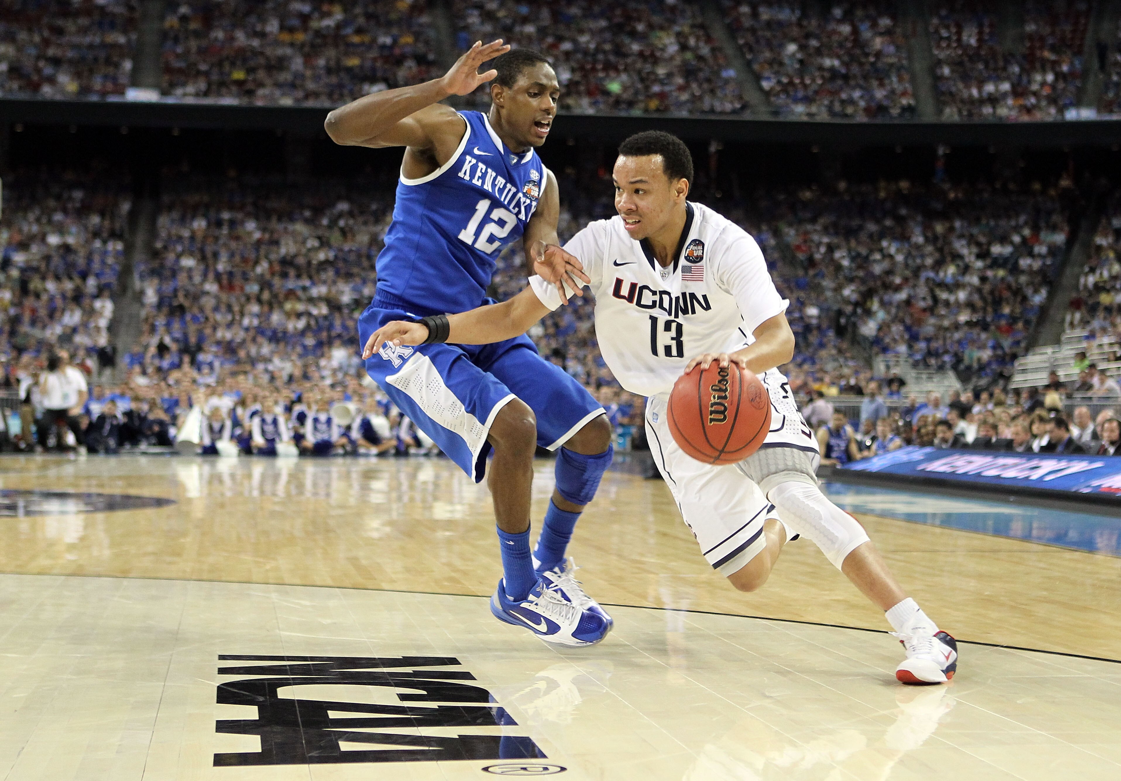 HOUSTON, TX - APRIL 02:  Shabazz Napier #13 of the Connecticut Huskies drives on Brandon Knight #12 of the Kentucky Wildcats during the National Semifinal game of the 2011 NCAA Division I Men's Basketball Championship at Reliant Stadium on April 2, 2011 i