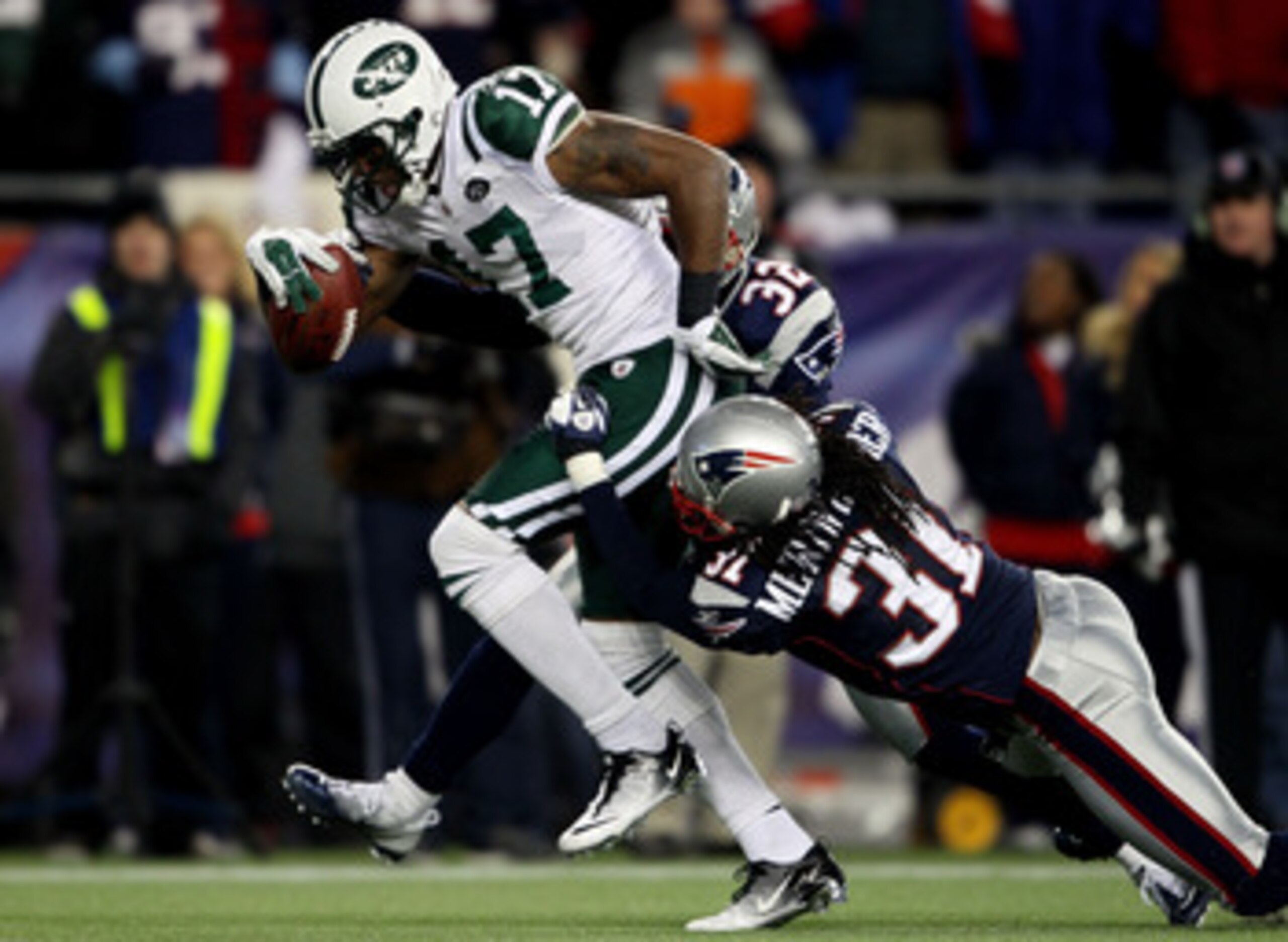 FOXBORO, MA - JANUARY 16: Braylon Edwards #17 of the New York Jets scores a second quarter touchdown as Devin McCourty #32 and Brandon Meriweather #31 of the New England Patriots attempt to tackle during their 2011 AFC divisional playoff game at Gillette FOXBORO, MA - JANUARY 16: Braylon Edwards #17 of the New York Jets scores a second quarter touchdown as Devin McCourty #32 and Brandon Meriweather #31 of the New England Patriots attempt to tackle during their 2011 AFC divisional playoff game at Gillette