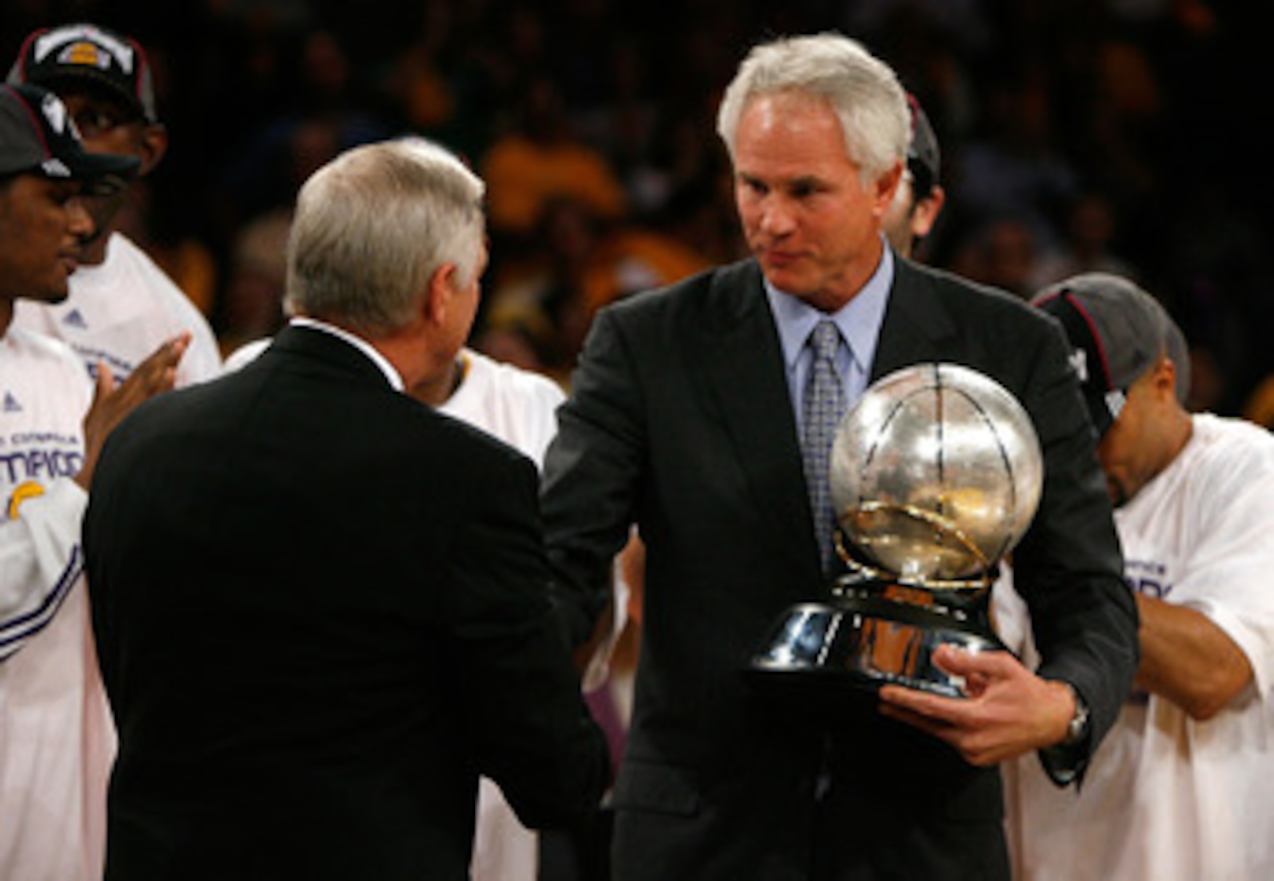 LOS ANGELES, CA - MAY 29:  (L-R) NBA legend Jerry West shakes hands with Los Angeles Lakers general manager Mitch Kupchak after defeating the Lakers defeated the San Antonio Spurs 100-92 in Game Five of the Western Conference Finals during the 2008 NBA Pl