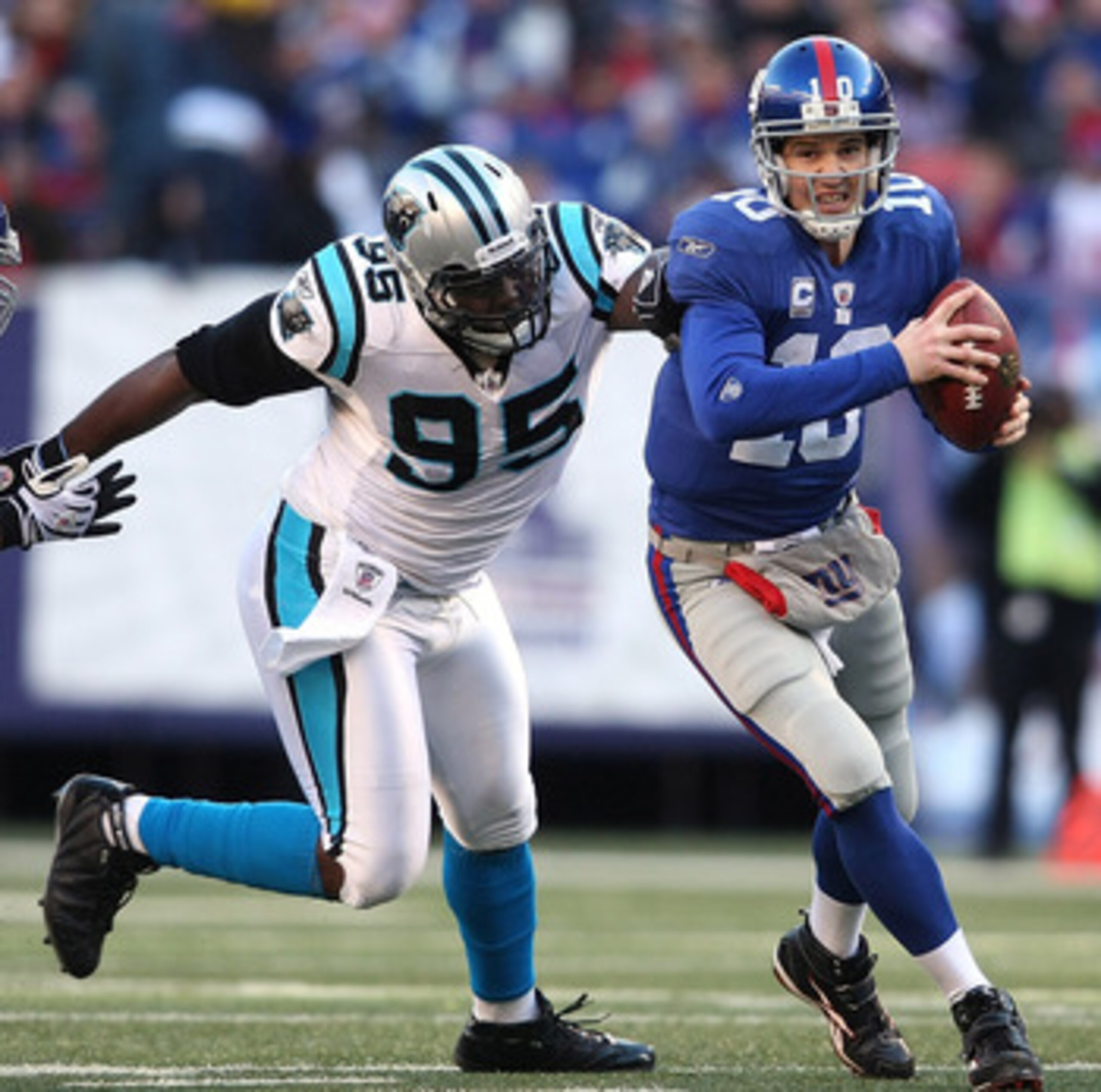 EAST RUTHERFORD, NJ - DECEMBER 27: Eli Manning #10 of the New York Giants is chased down Charles Johnson #95 of the Carolina Panthers at Giants Stadium on December 27, 2009 in East Rutherford, New Jersey. (Photo by Nick Laham/Getty Images) EAST RUTHERFORD, NJ - DECEMBER 27: Eli Manning #10 of the New York Giants is chased down Charles Johnson #95 of the Carolina Panthers at Giants Stadium on December 27, 2009 in East Rutherford, New Jersey. (Photo by Nick Laham/Getty Images)