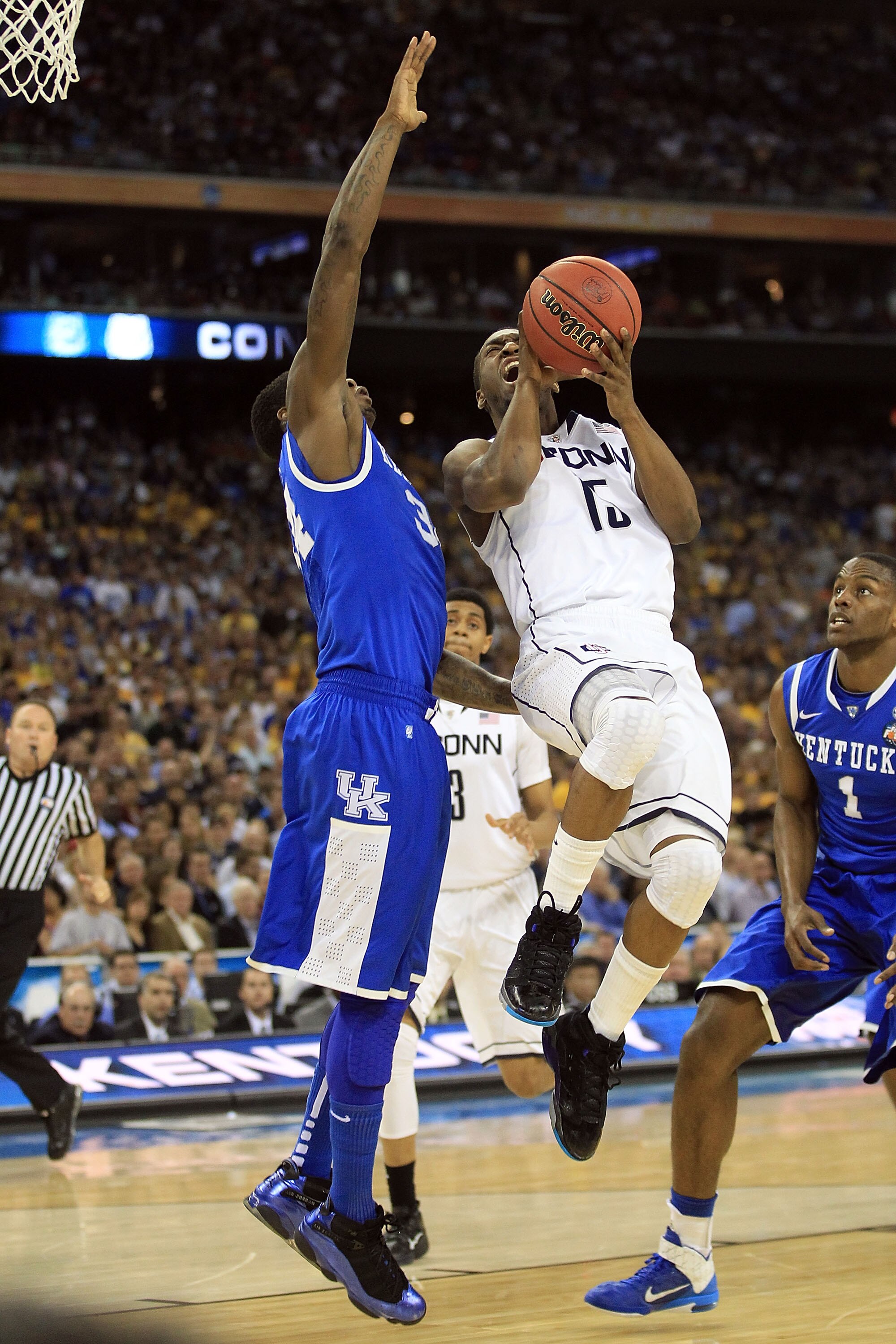 HOUSTON, TX - APRIL 02:  Kemba Walker #15 of the Connecticut Huskies goes to the hoop against DeAndre Liggins #34 of the Kentucky Wildcats during the National Semifinal game of the 2011 NCAA Division I Men's Basketball Championship at Reliant Stadium on A