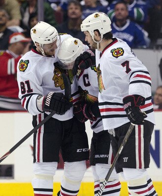 VANCOUVER, CANADA - APRIL 26: Jonathan Toews #19 of the Chicago Blackhawks is congratulated by Marian Hossa #81 and Brent Seabrook #7 after scoring the game tying goal during the third period in Game Seven of the Western Conference Quarterfinals during th