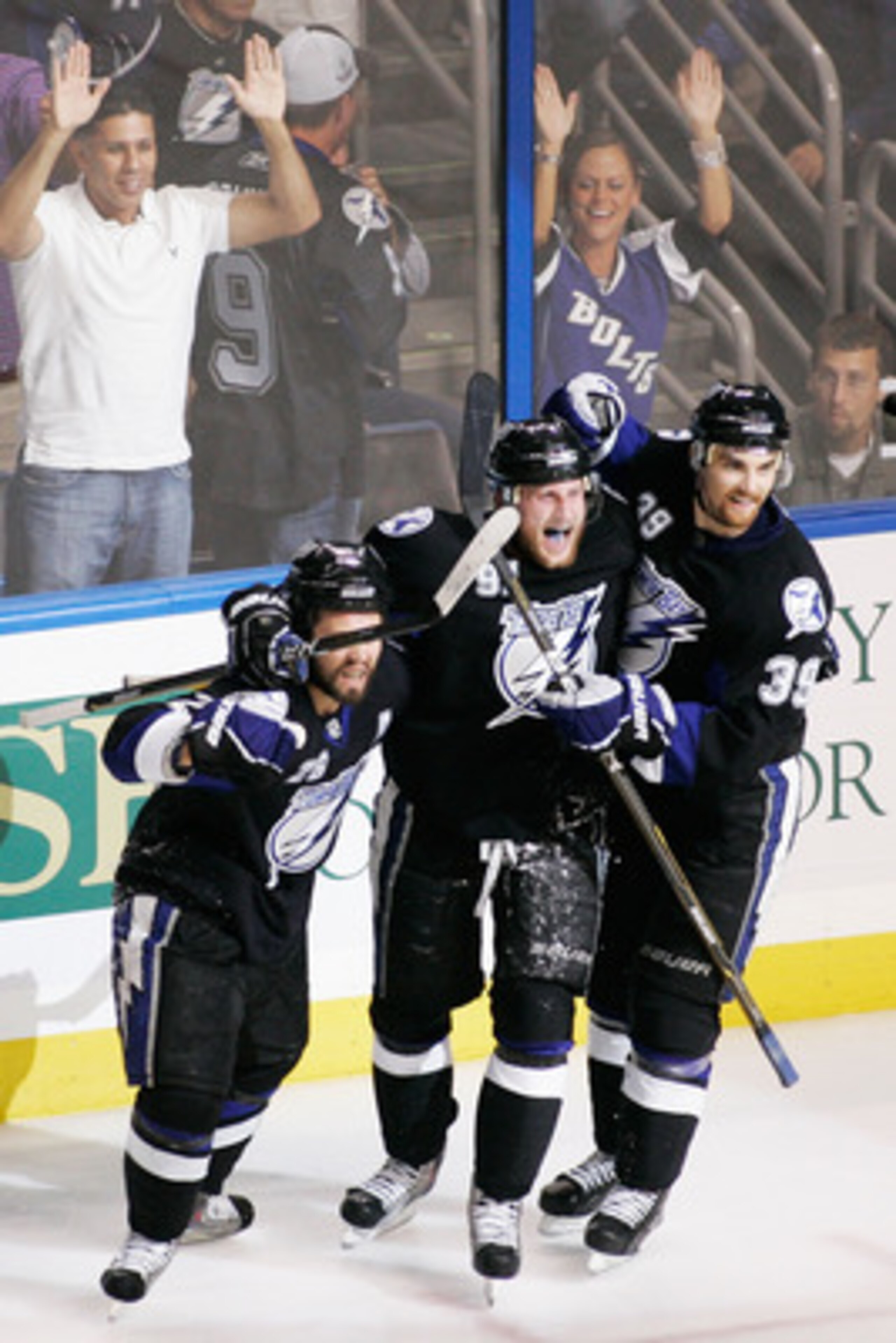 TAMPA, FL - MAY 25: Martin St. Louis #26 celebrates his third period goal with Steven Stamkos #91 and Mike Lundin #39 of the Tampa Bay Lightning in Game Six of the Eastern Conference Finals against the Boston Bruins during the 2011 NHL Stanley Cup Playof TAMPA, FL - MAY 25: Martin St. Louis #26 celebrates his third period goal with Steven Stamkos #91 and Mike Lundin #39 of the Tampa Bay Lightning in Game Six of the Eastern Conference Finals against the Boston Bruins during the 2011 NHL Stanley Cup Playof