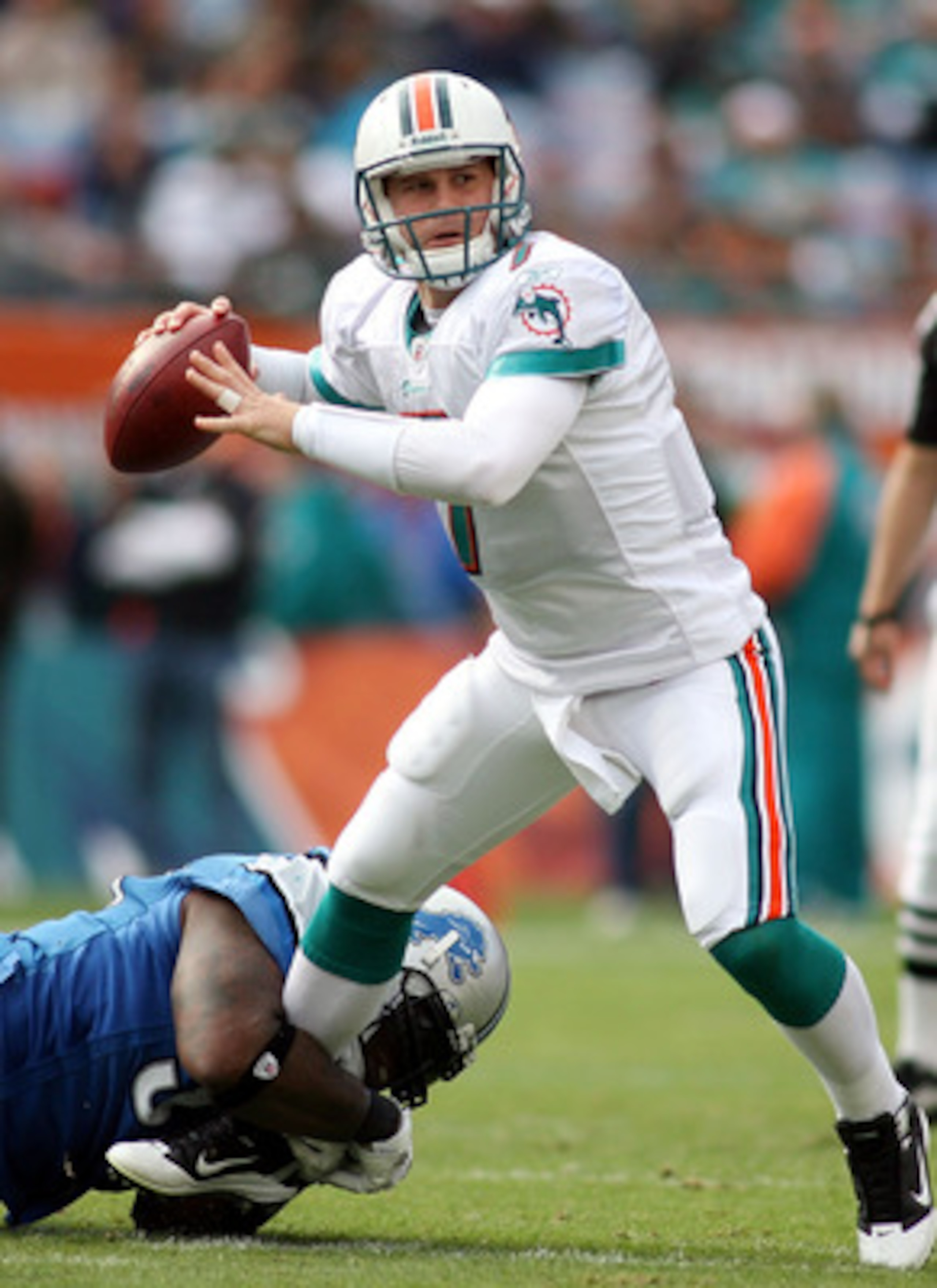 MIAMI - DECEMBER 26:  Quarterback Chad Henne #7 of the Miami Dolphins is preasured by Lawrence Jackson #94 of the Detroit Lions at Sun Life Stadium on December 26, 2010 in Miami, Florida.  (Photo by Marc Serota/Getty Images)