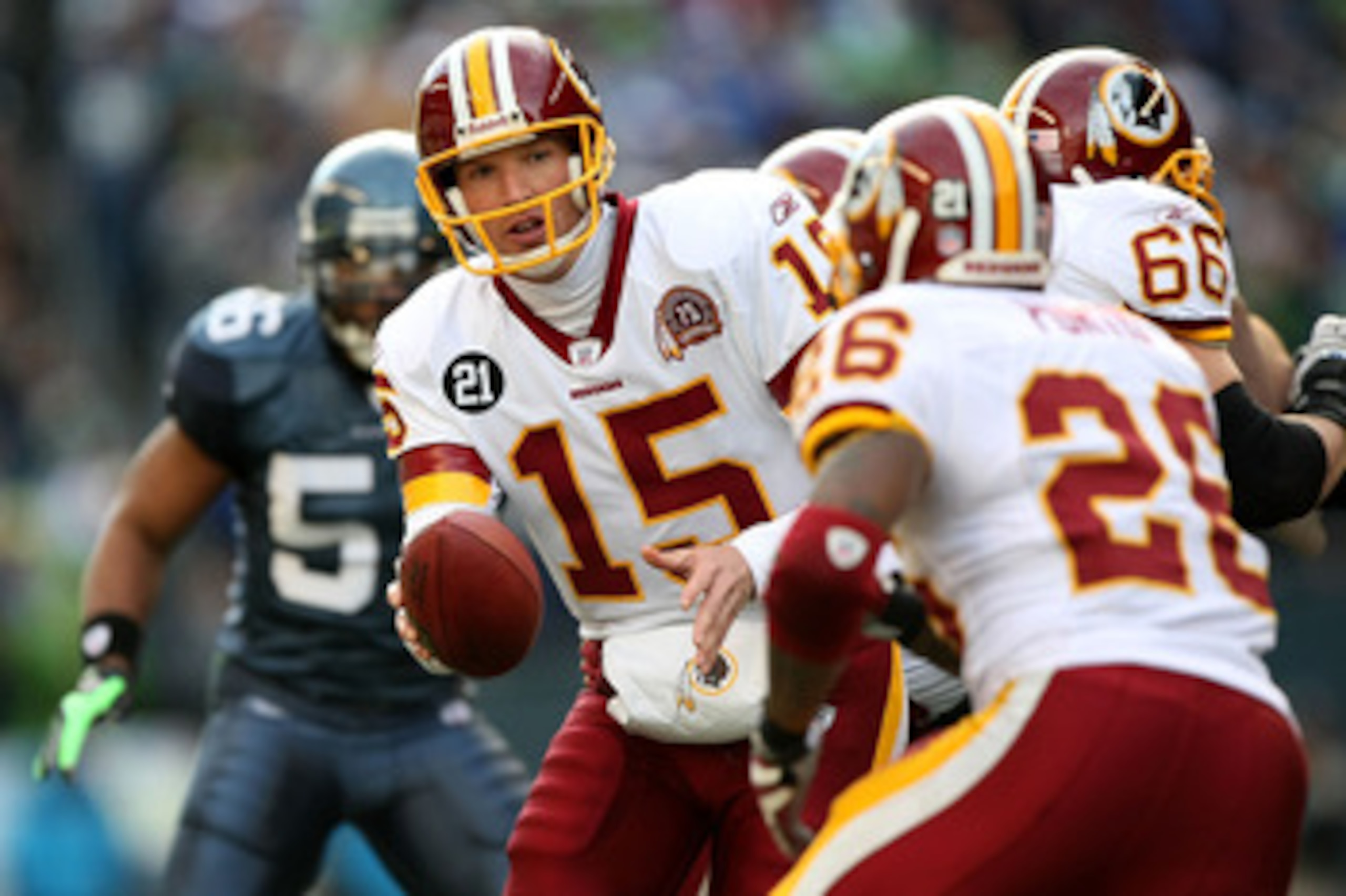 SEATTLE - JANUARY 05:  Quarterback Todd Collins #15 of the Washington Redskins hands the ball off to running back Clinton Portis #26 against the Seattle Seahawks in the first quarter during the NFC Wild Card game at Qwest Field on January 5, 2008 in Seatt
