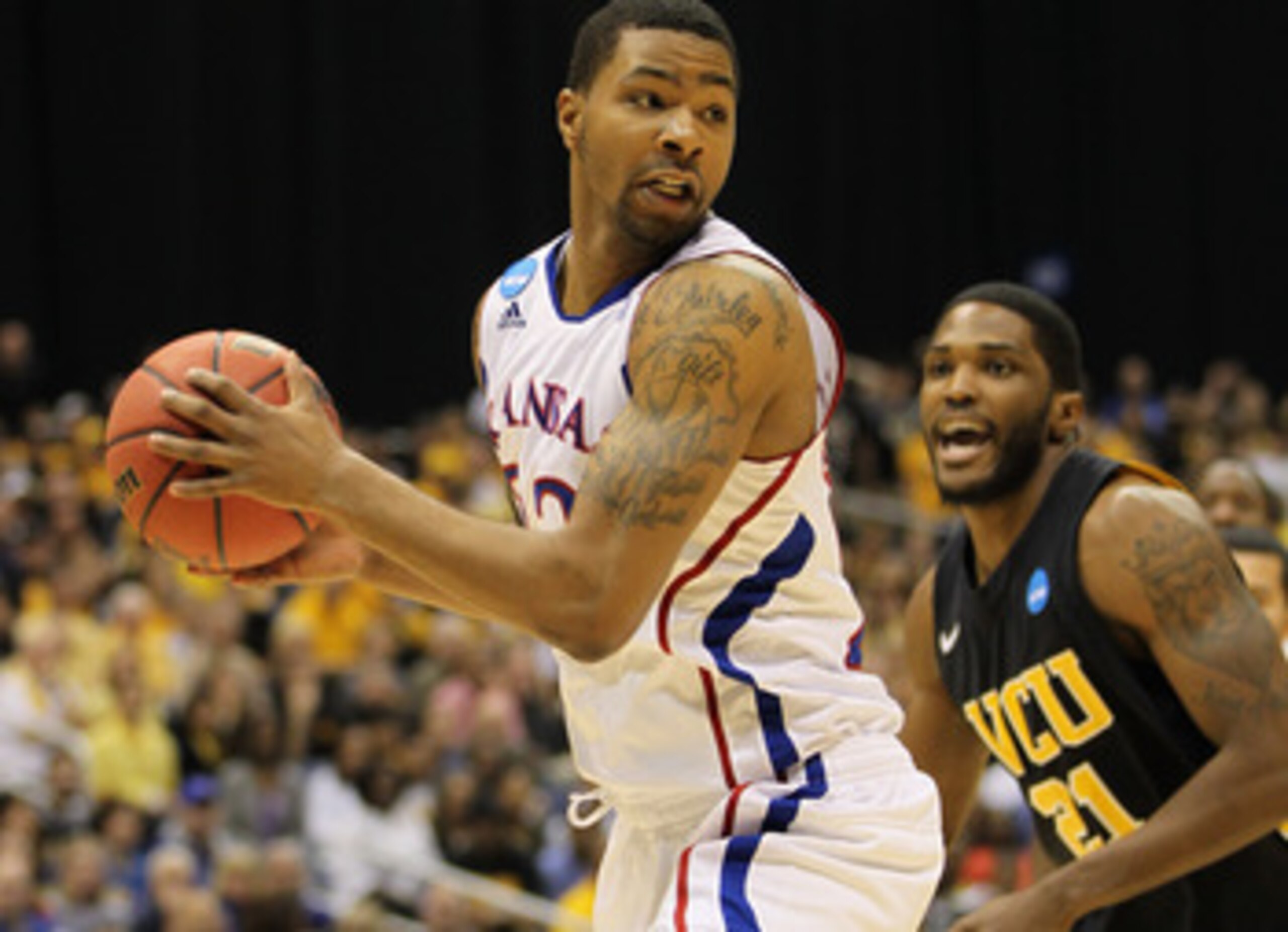 SAN ANTONIO, TX - MARCH 27:  Marcus Morris #22 of the Kansas Jayhawks handles the ball against Jamie Skeen #21 of the Virginia Commonwealth Rams during the southwest regional final of the 2011 NCAA men's basketball tournament at the Alamodome on March 27,