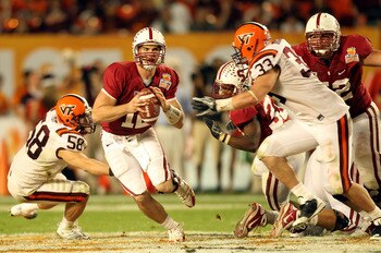 MIAMI, FL - JANUARY 03:  Andrew Luck #12 of the Stanford Cardinal looks to pass under pressure from Chris Drager #33 and Jack Tyler #58 of the Virginia Tech Hokies during the 2011 Discover Orange Bowl at Sun Life Stadium on January 3, 2011 in Miami, Flori
