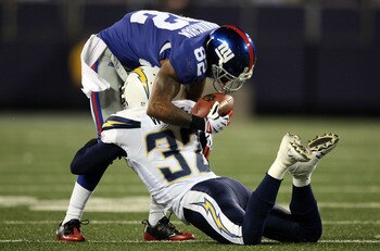 EAST RUTHERFORD, NJ - NOVEMBER 08: Mario Manningham #82 of the New York Giants is tackled by Eric Weddle #32 of the San Diego Chargers at Giants Stadium on November 8, 2009 in East Rutherford, New Jersey.  (Photo by Nick Laham/Getty Images)