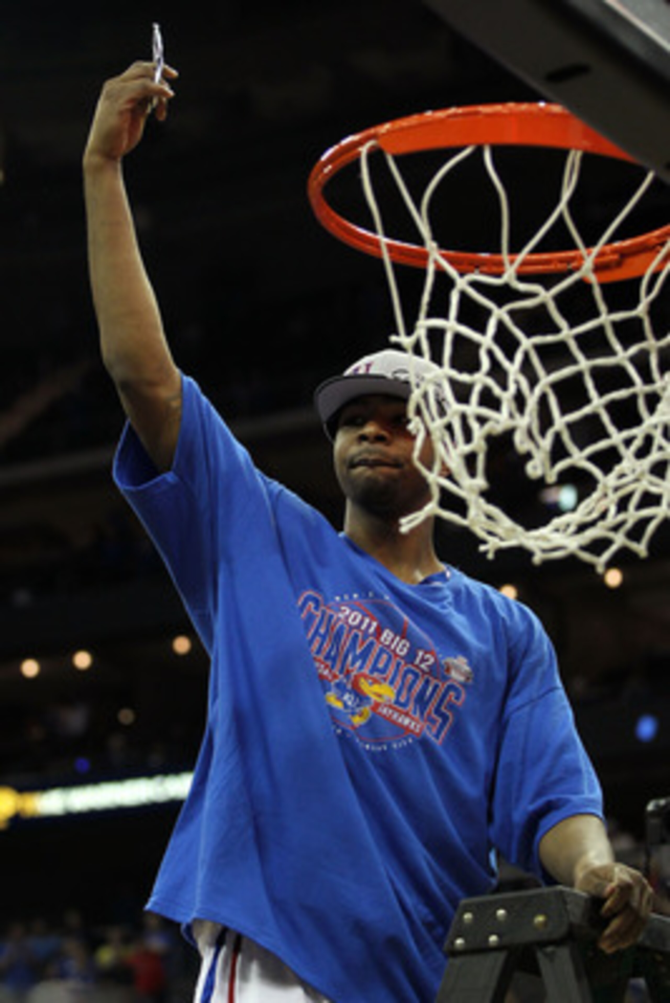 KANSAS CITY, MO - MARCH 12:  Marcus Morris #22 of the Kansas Jayhawks cuts down the net after defeating the Texas Longhorns 85-73 in the 2011 Phillips 66 Big 12 Men's Basketball Tournament championship game at Sprint Center on March 12, 2011 in Kansas Cit