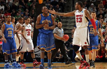 DENVER, CO - MARCH 17:  Kenneth Faried #35 of the Morehead State Eagles reacts after a play as Terrence Jennings #23 of the Louisville Cardinals looks on during the second round of the 2011 NCAA men's basketball tournament at Pepsi Center on March 17, 201