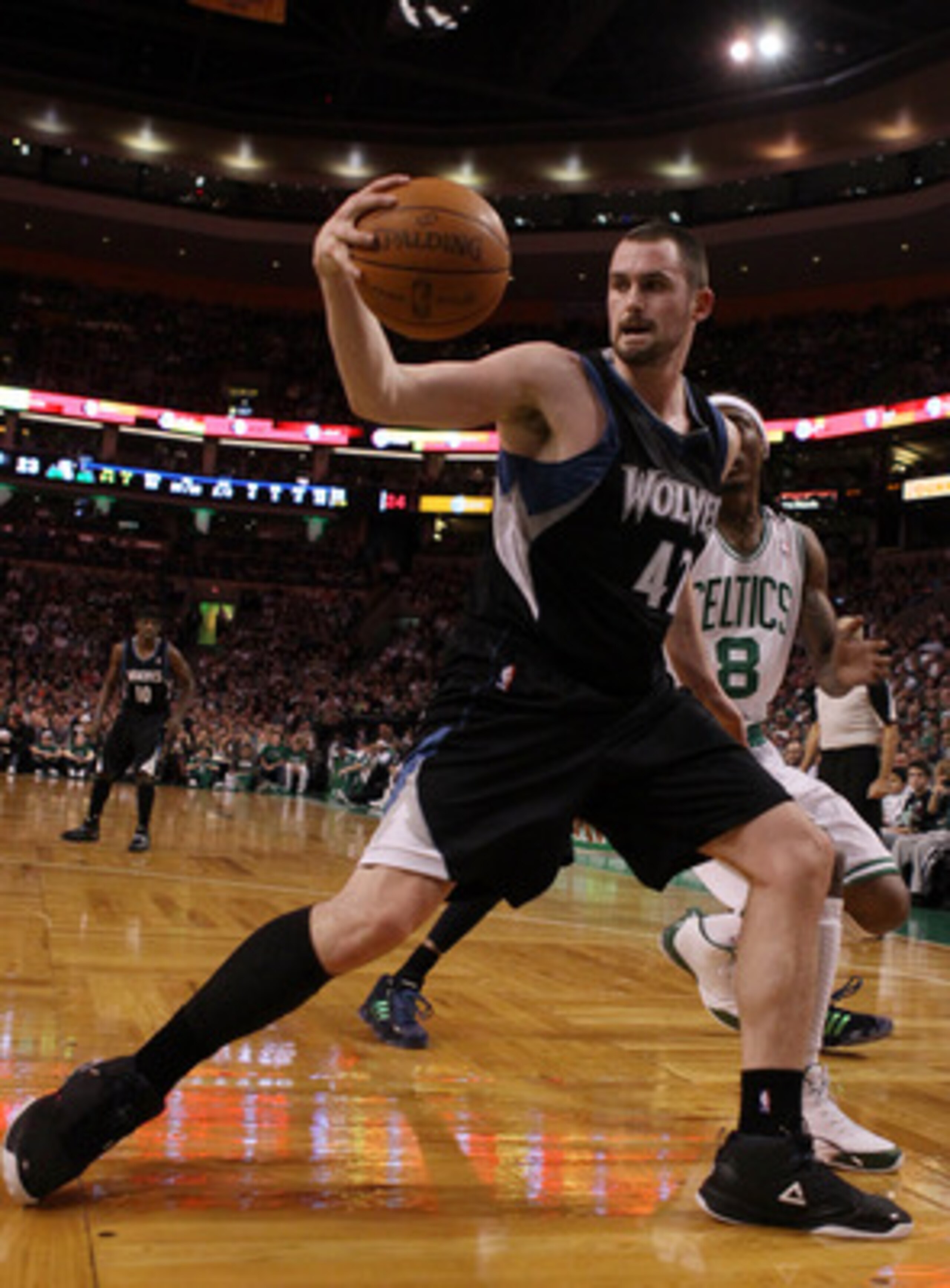 BOSTON, MA - JANUARY 03:  Kevin Love #42 of the Minnesota Timberwolves grabs the loose ball as Marquis Daniels #8 of the Boston Celtics defends on January 3, 2011 at the TD Garden in Boston, Massachusetts. NOTE TO USER: User expressly acknowledges and agr
