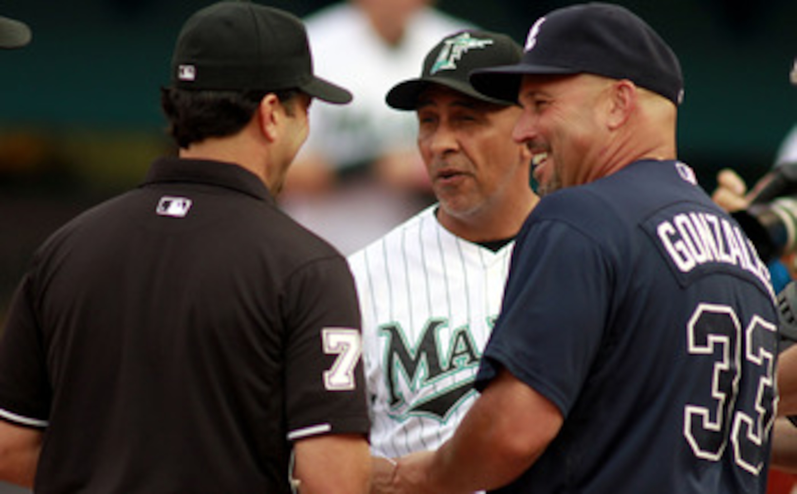 MIAMI GARDENS, FL - JUNE 07:  Manager Edwin Rodriguez of the Florida Marlins and former Marlins Manager Freddie Gonzalez #33 of the Atlanta Braves chats with the umpire prior to their game at Sun Life Stadium on June 7, 2011 in Miami Gardens, Florida.  Th