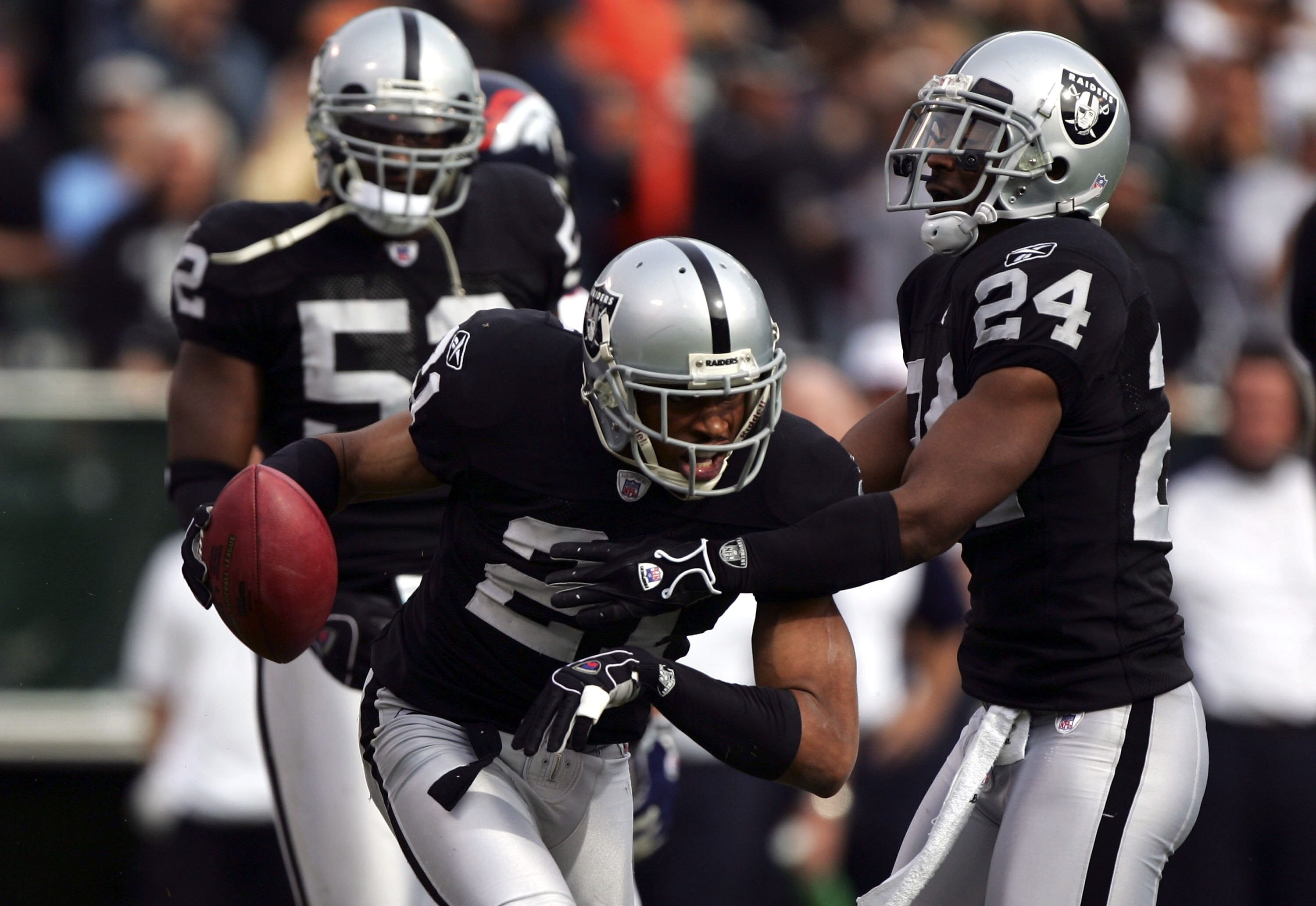 OAKLAND, CA - NOVEMBER 12:  Nnamdi Asomugha #21 of the Oakland Raiders celebrates with Michael Huff #24 after making an interception against the Denver Broncos during the first quarter of an NFL game at McAfee Coliseum on November 12, 2006 in Oakland, Cal