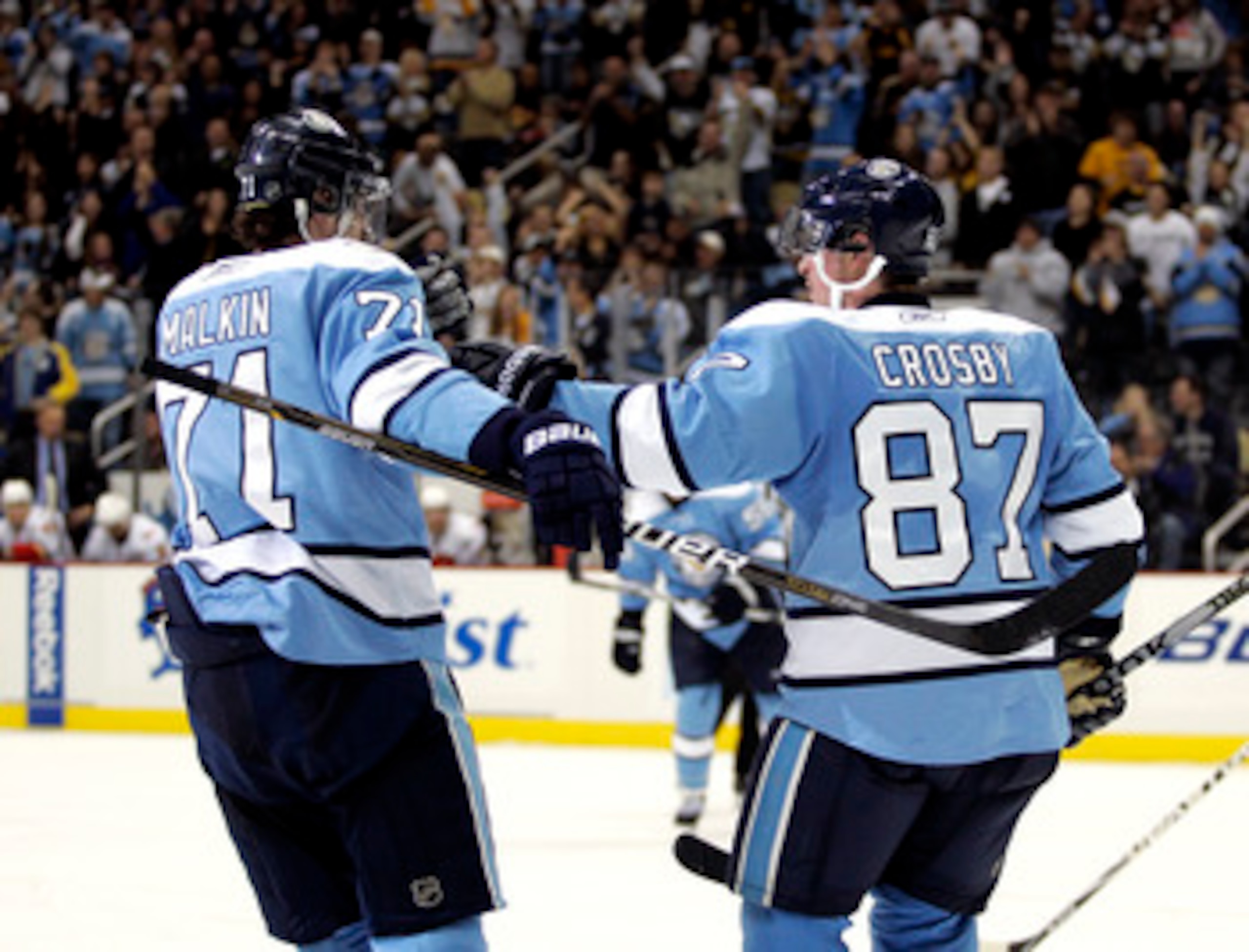 PITTSBURGH - NOVEMBER 27: Sidney Crosby #87 of the Pittsburgh Penguins celebrates his 200th career goal with Evgeni Malkin #71 against the Calgary Flames at Consol Energy Center on November 27, 2010 in Pittsburgh, Pennsylvania. The Penguins defeated the PITTSBURGH - NOVEMBER 27: Sidney Crosby #87 of the Pittsburgh Penguins celebrates his 200th career goal with Evgeni Malkin #71 against the Calgary Flames at Consol Energy Center on November 27, 2010 in Pittsburgh, Pennsylvania. The Penguins defeated the