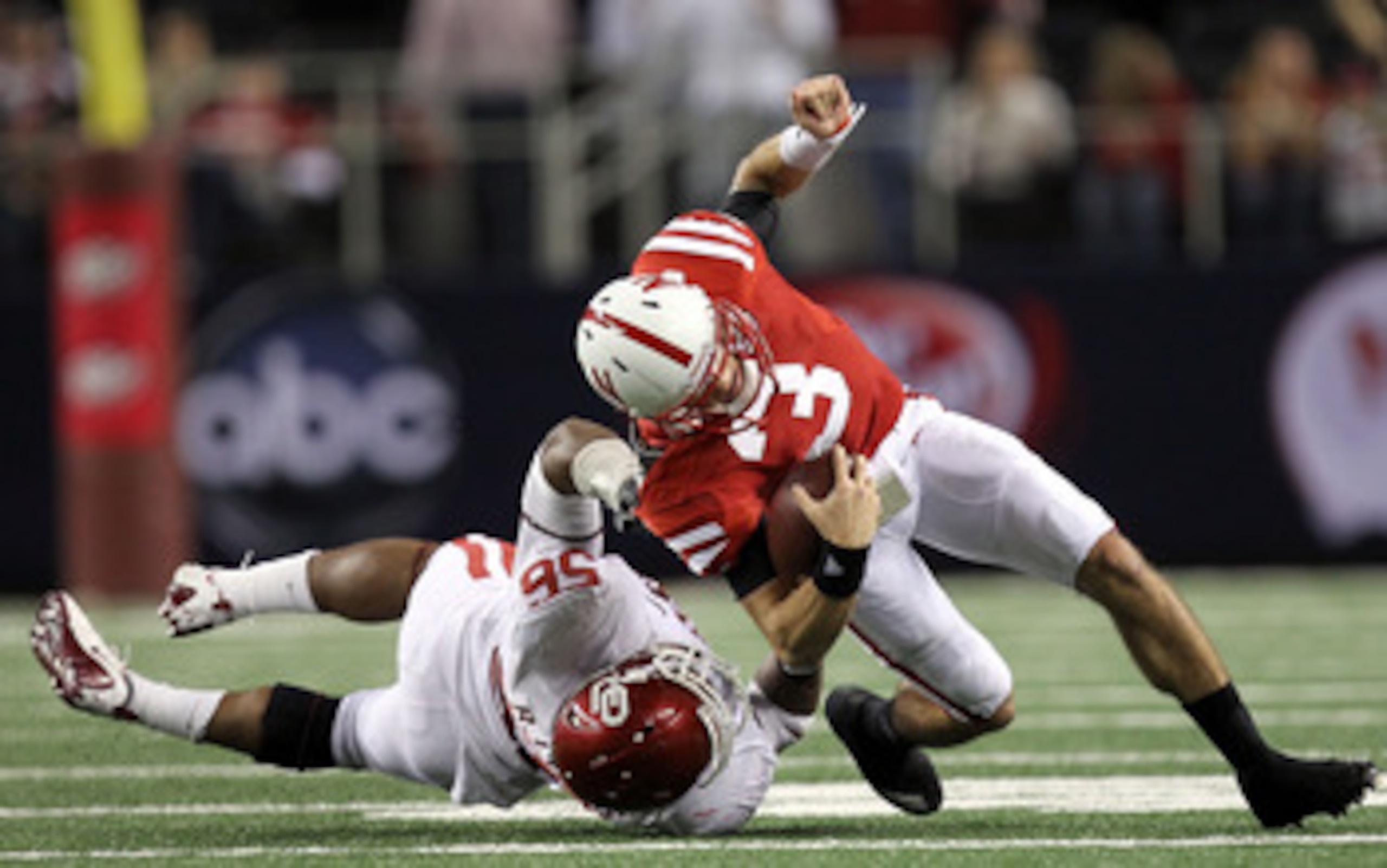ARLINGTON, TX - DECEMBER 04:  Quarterback Taylor Martinez #3 of the Nebraska Cornhuskers is tackled by Ronnell Lewis #56 of the Oklahoma Sooners during the Big 12 Championship at Cowboys Stadium on December 4, 2010 in Arlington, Texas.  (Photo by Ronald M