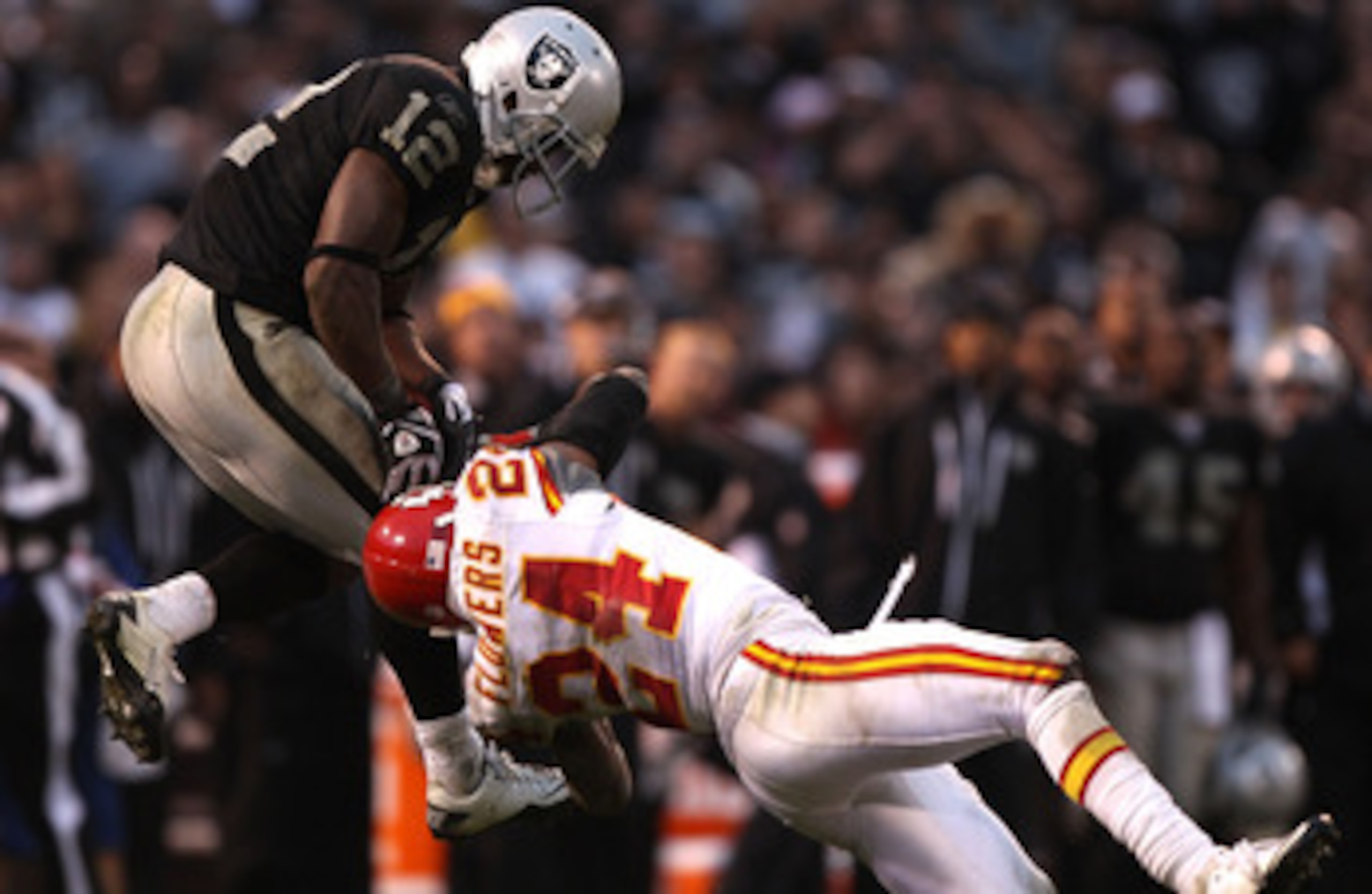 OAKLAND, CA - NOVEMBER 07:  Jacoby Ford #12 of the Oakland Raiders catches a pass over Brandon Flowers #24 of the Kansas City Chiefs during an NFL game at Oakland-Alameda County Coliseum on November 7, 2010 in Oakland, California.  (Photo by Jed Jacobsohn