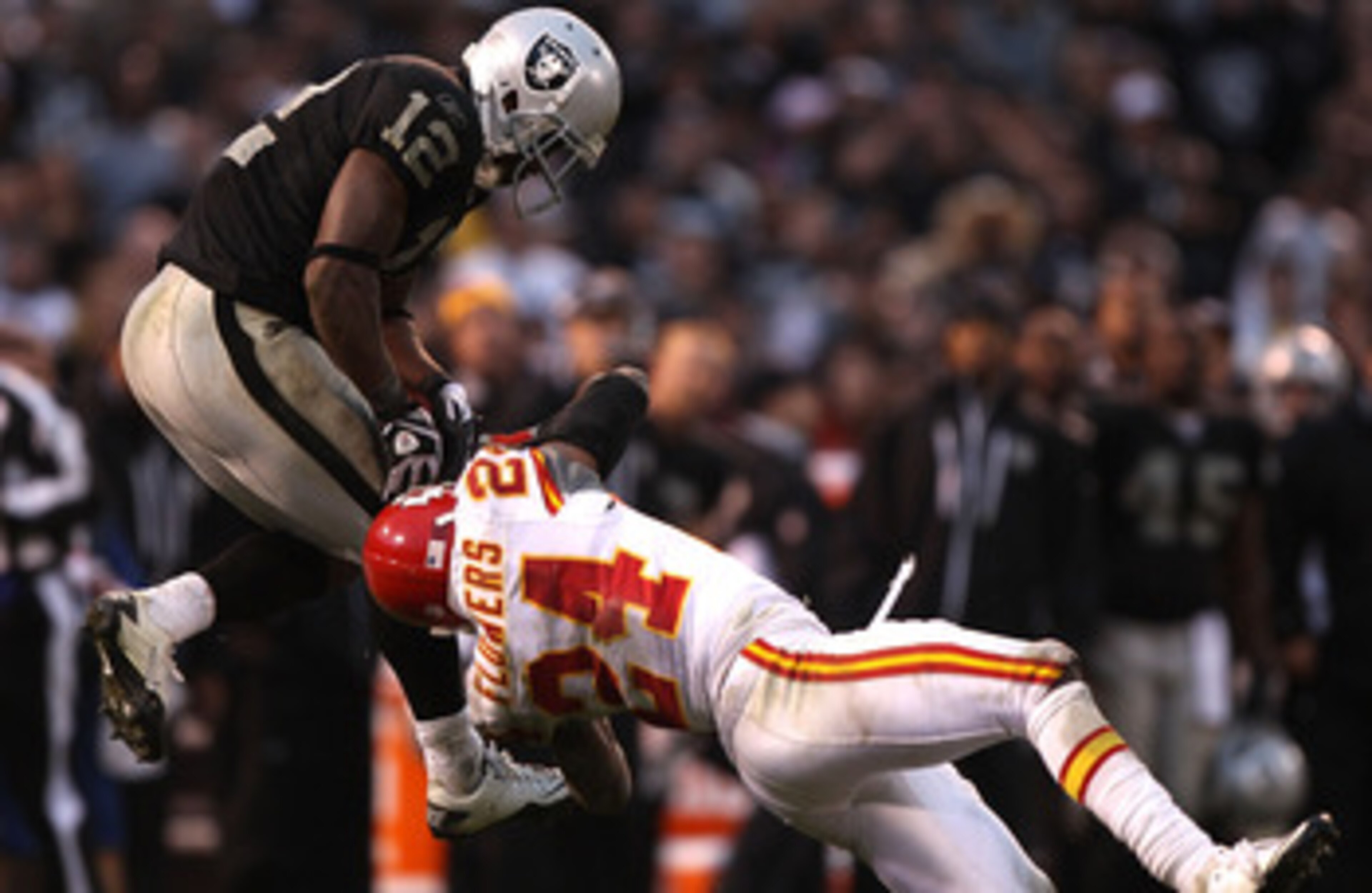 OAKLAND, CA - NOVEMBER 07:  Jacoby Ford #12 of the Oakland Raiders catches a pass over Brandon Flowers #24 of the Kansas City Chiefs during an NFL game at Oakland-Alameda County Coliseum on November 7, 2010 in Oakland, California.  (Photo by Jed Jacobsohn