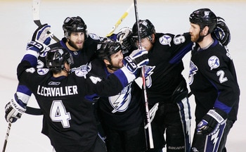 TAMPA, FL - MAY 25:  Martin St. Louis #26 of the Tampa Bay Lightning celebrates his second period goal with teammates in Game Six of the Eastern Conference Finals against the Boston Bruins during the 2011 NHL Stanley Cup Playoffs at St Pete Times Forum on