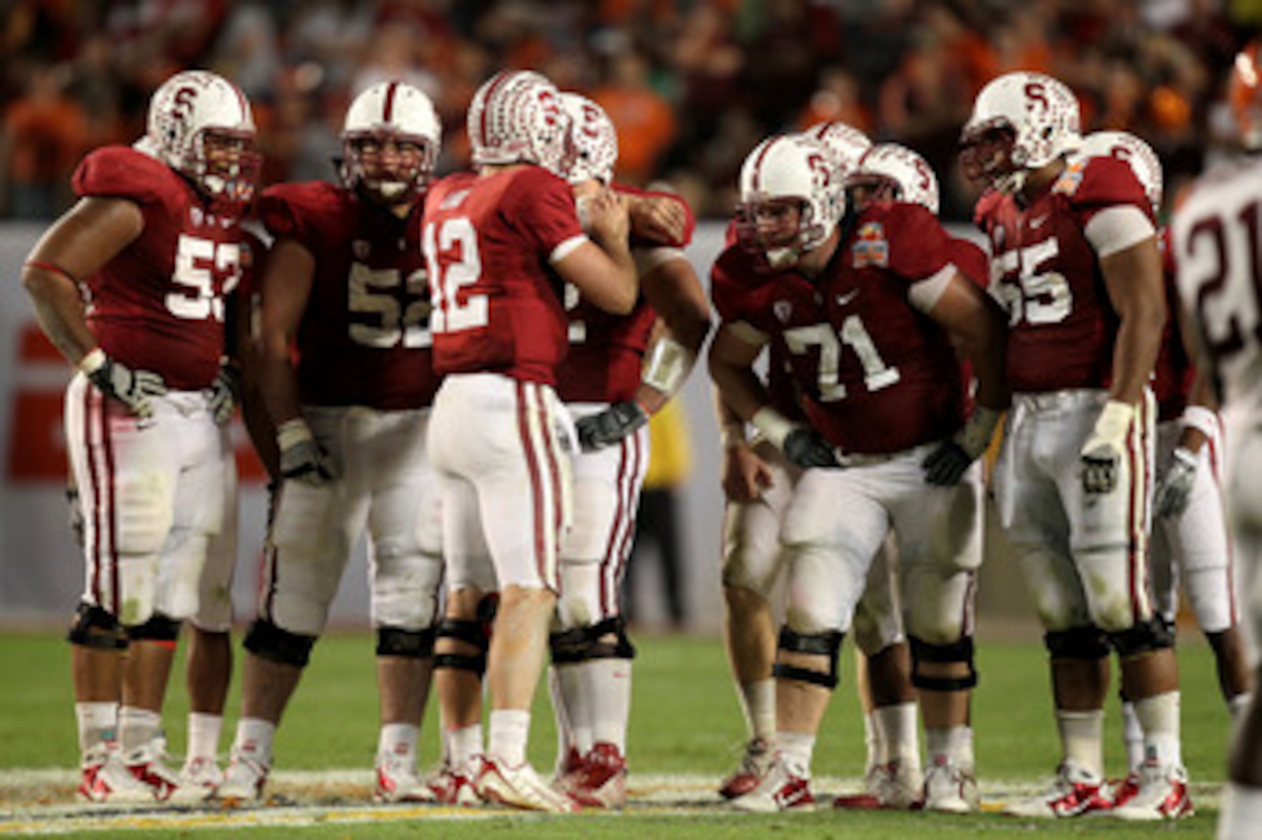 MIAMI, FL - JANUARY 03:  Quarterback Andrew Luck #12 of the Stanford Cardinal calls a play in the huddle as Derek Hall #53, David DeCastro #52, Andrew Phillips #71 and Jonathan Martin #55 listen to the call against the Virginai Tech Hokies during the 2011