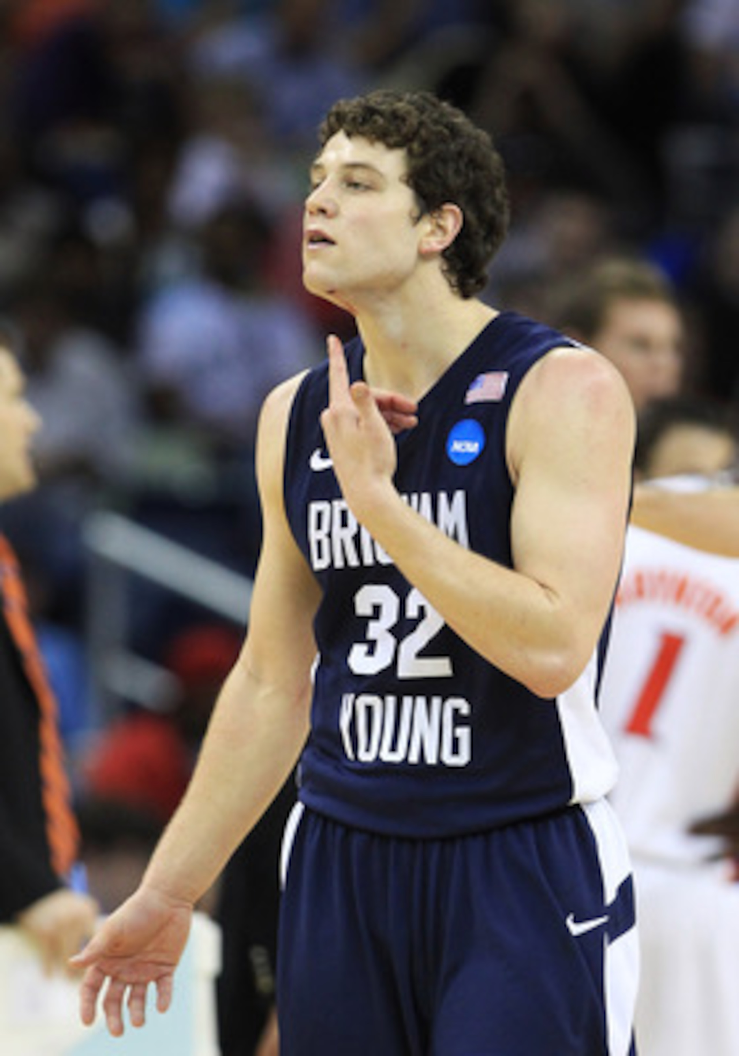 NEW ORLEANS, LA - MARCH 24:  Jimmer Fredette #32 of the Brigham Young Cougars reacts after being injured during their game against the Florida Gators in the Southeast regional of the 2011 NCAA men's basketball tournament at New Orleans Arena on March 24,
