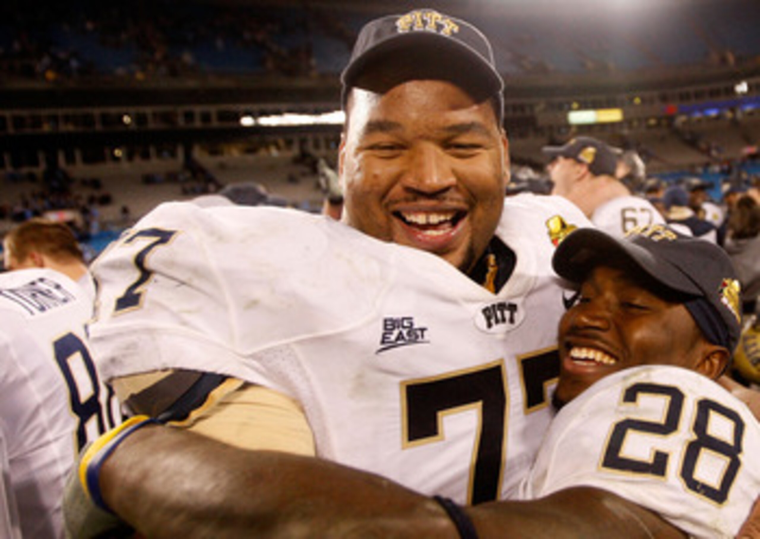 CHARLOTTE, NC - DECEMBER 26:  Teammates Jason Pinkston #77 and Dion Lewis #28 of the Pittsburgh Panthers celebrates after a 19-17 victory over the North Carolina Tar Heels on December 26, 2009 in Charlotte, North Carolina.  (Photo by Streeter Lecka/Getty 