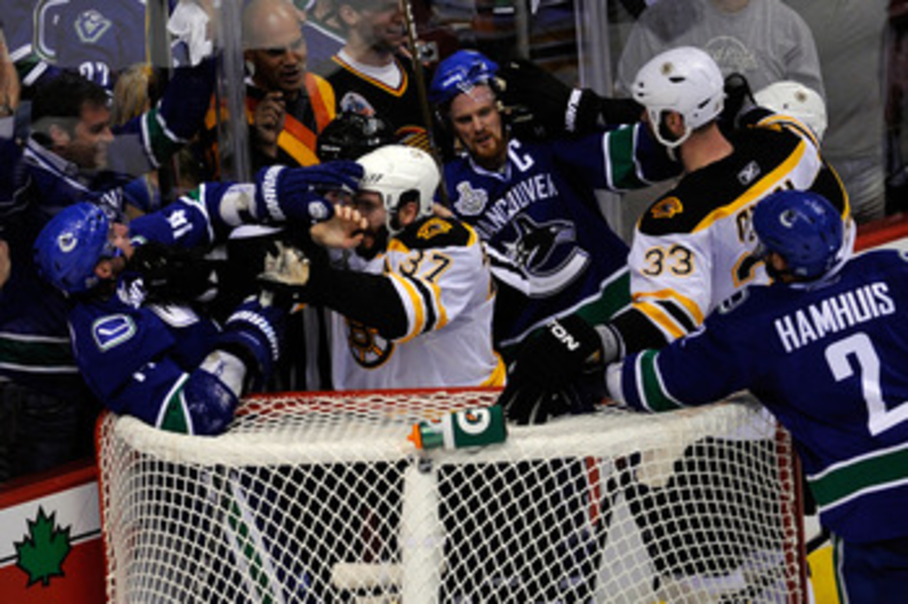 VANCOUVER, BC - JUNE 01:  Alex Burrows #14 of the Vancouver Canucks fights with Patrice Bergeron #37 of the Boston Bruins as Henrik Sedin #33 of the Vancouver Canucks and Zdeno Chara #33 of the Boston Bruins fight during game one of the 2011 NHL Stanley C