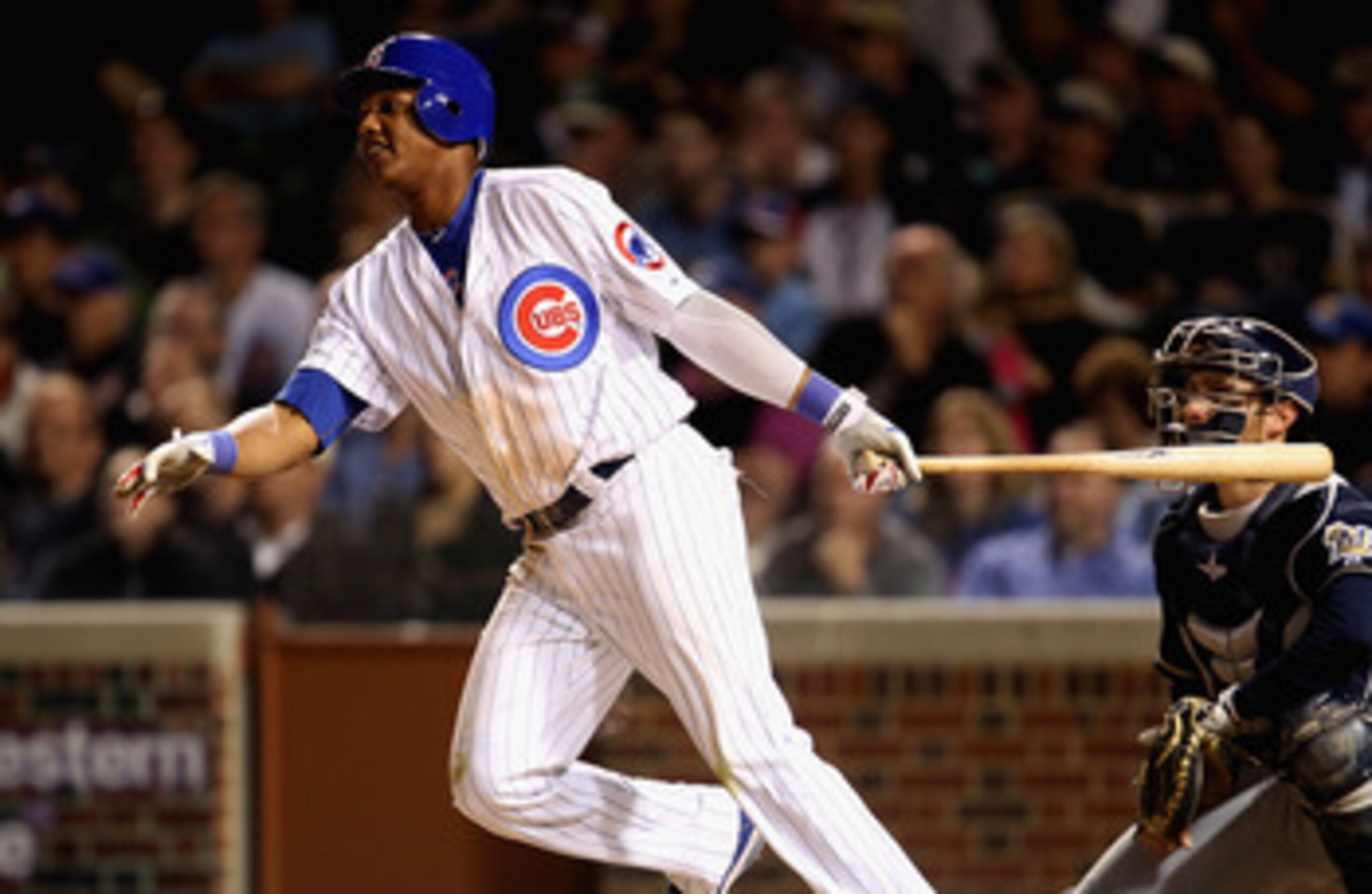 CHICAGO, IL - JUNE 14:  Starlin Castro #13 of the Chicago Cubs hits a double against the Milwaukee Brewers at Wrigley Field on June 14, 2011 in Chicago, Illinois. The Cubs defeated the Brewers 5-4 in 10 innings.  (Photo by Jonathan Daniel/Getty Images)