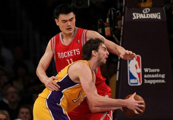 LOS ANGELES, CA - OCTOBER 26:  Pau Gasol #16 of the Los Angeles Lakers looks to score as Yao Ming #11 of the Houston Rockets defends during their NBA game at Staples Center on October 26, 2010 in Los Angeles, California. NOTE TO USER: User expressly ackno