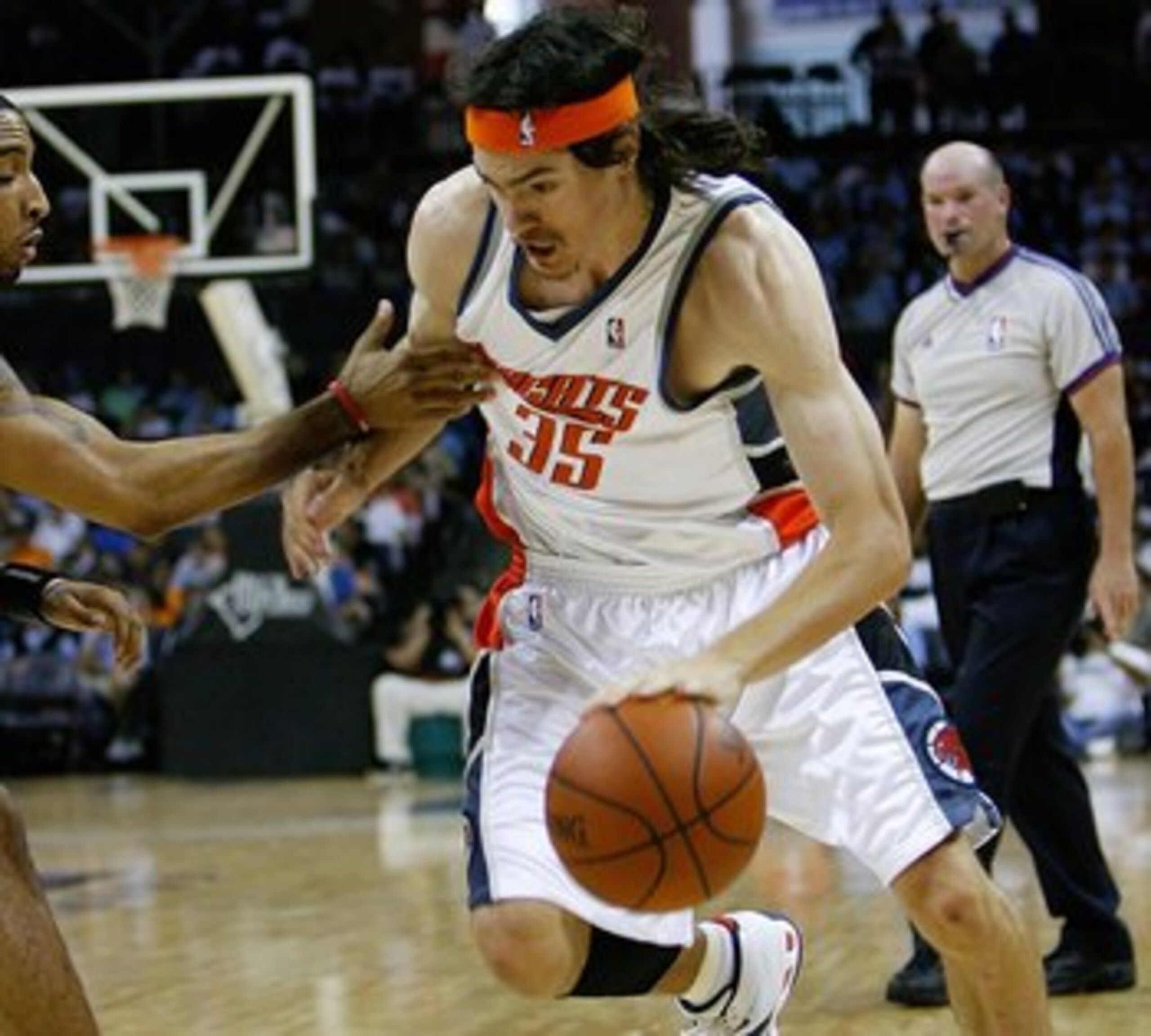 CHARLOTTE, NC - OCTOBER 18:  Adam Morrison #35 of the Charlotte Bobcats drives the ball around Acie Law #4 of the Atlanta Hawks during the game at Charlotte Bobcats Arena on October 18, 2007 in Charlotte, North Carolina.  The Hawks won 104-98.  NOTE TO US