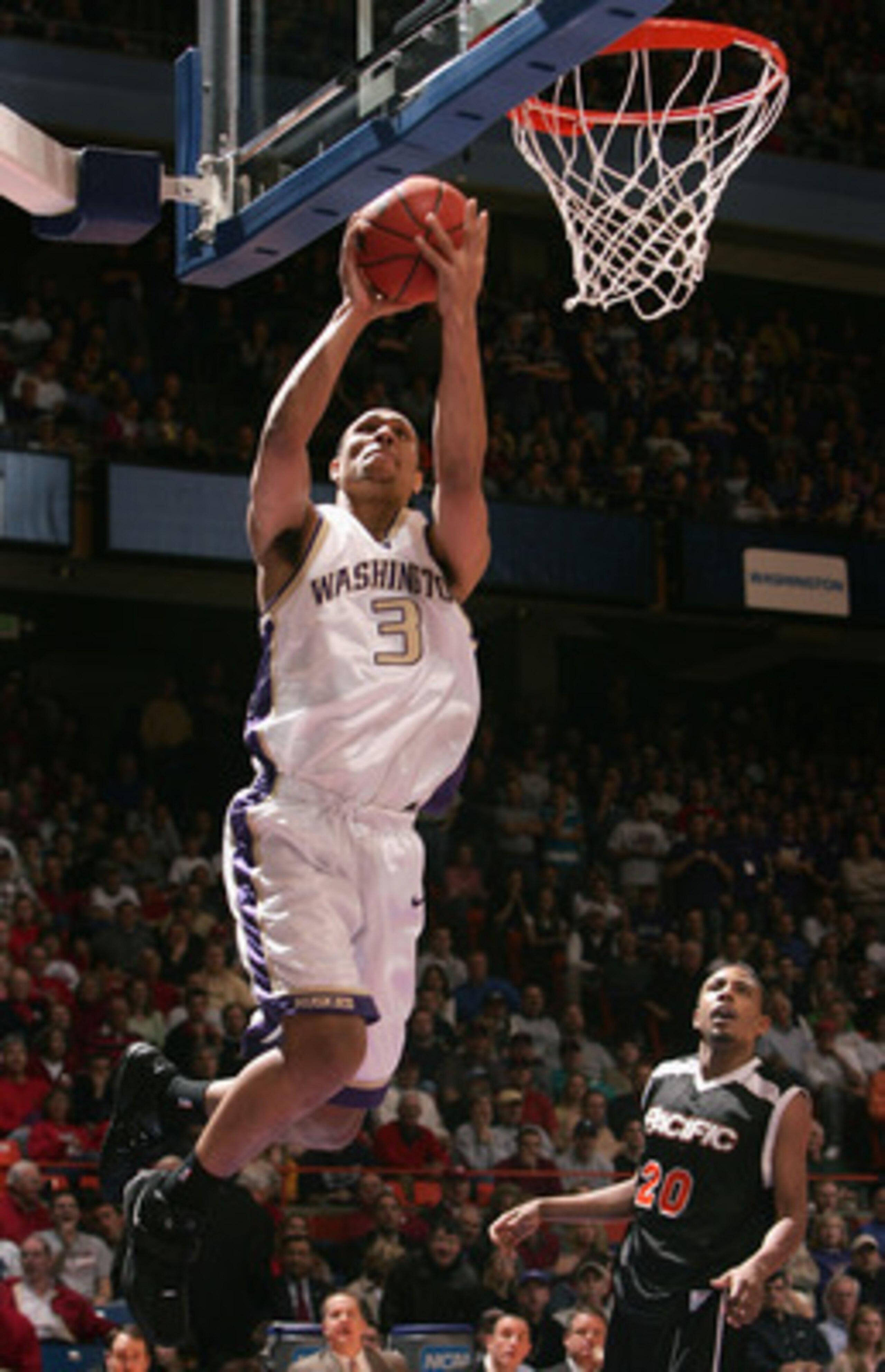BOISE, ID - MARCH 19: Brandon Roy #3 of the Washington Huskies lays up a shot over David Doubley #20 of the Pacific Tigers during the 2005 NCAA division 1 men's basketball championship tournament game at Taco Bell Arena on March 19, 2005 in Boise, Idaho. BOISE, ID - MARCH 19: Brandon Roy #3 of the Washington Huskies lays up a shot over David Doubley #20 of the Pacific Tigers during the 2005 NCAA division 1 men's basketball championship tournament game at Taco Bell Arena on March 19, 2005 in Boise, Idaho.